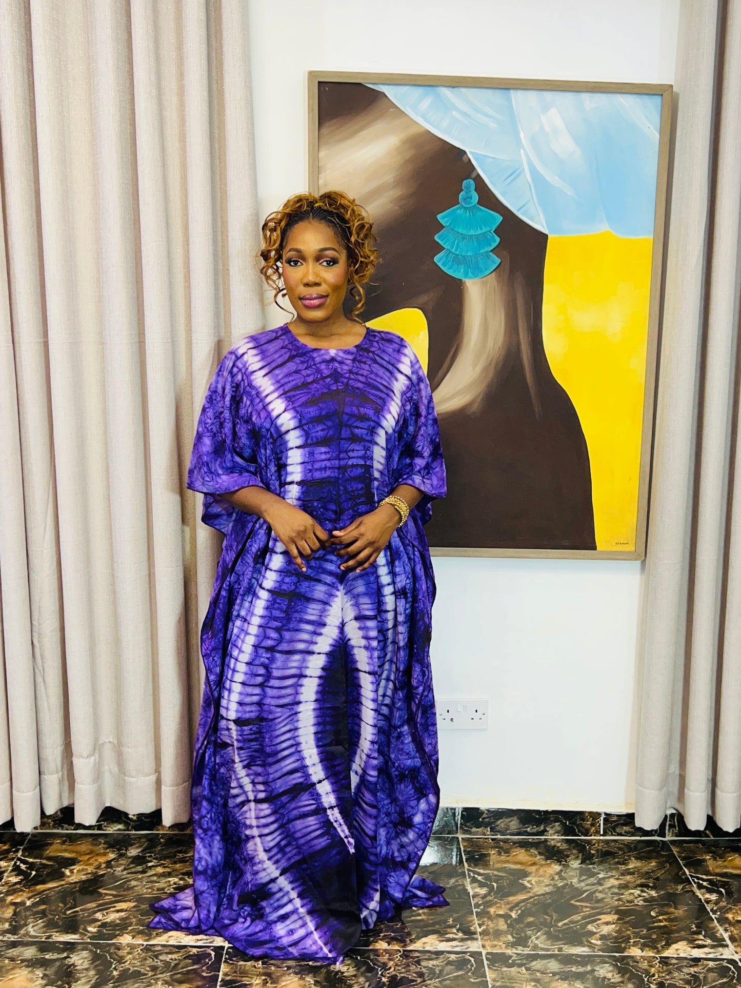 African woman wearing a handmade silk adire boubou dress – full-length traditional kaftan for women
