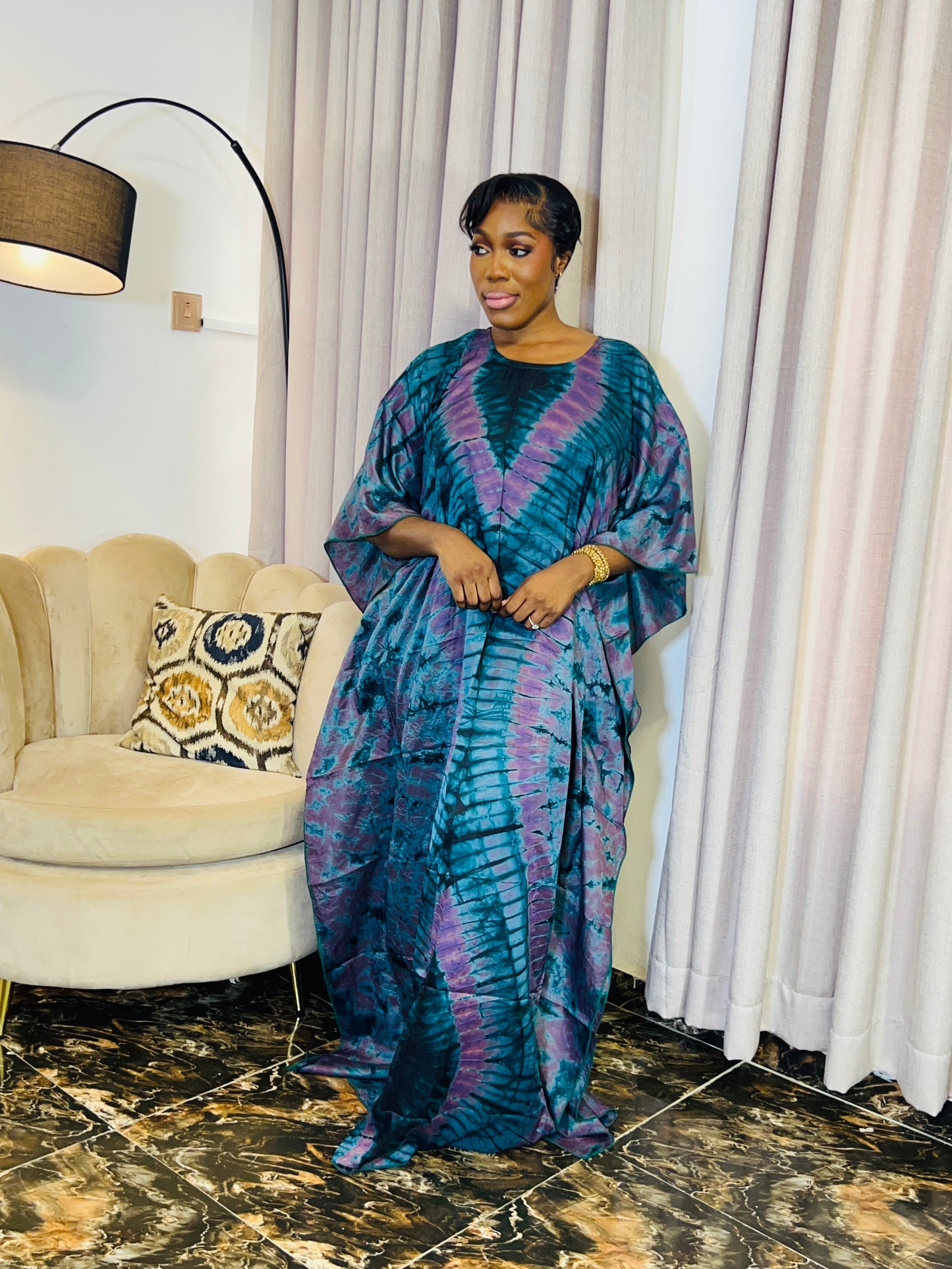 African woman wearing a handmade silk adire boubou dress – full-length traditional kaftan for women