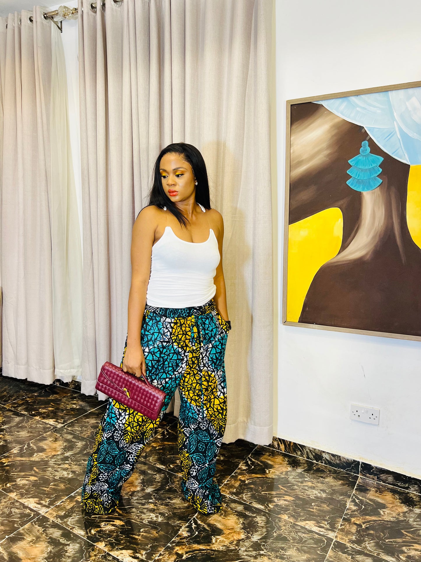 Wide-leg Ankara pants in bold spiral print, styled for soft life days.