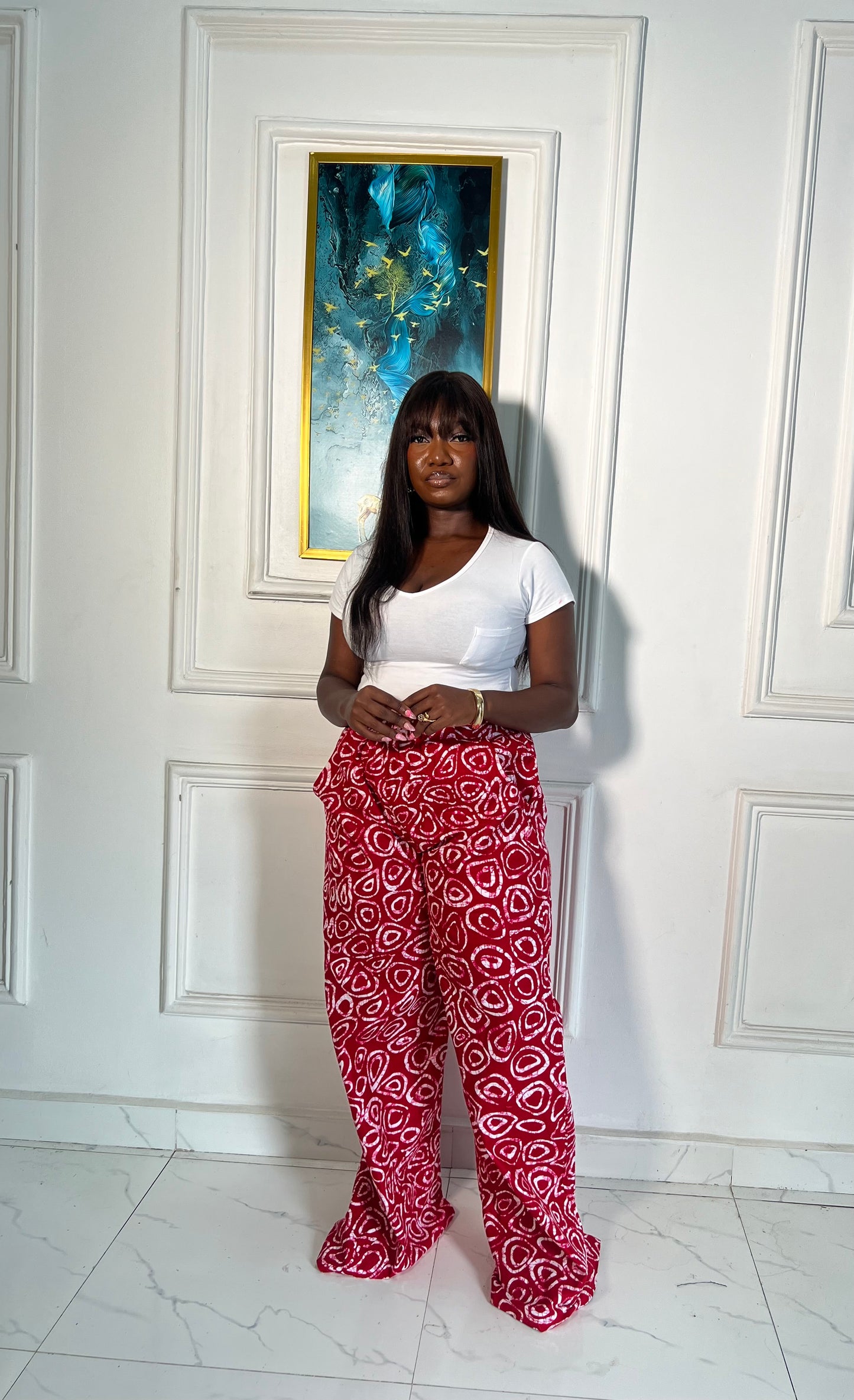 Wide-leg Ankara pants in bold spiral print, styled for soft life days.