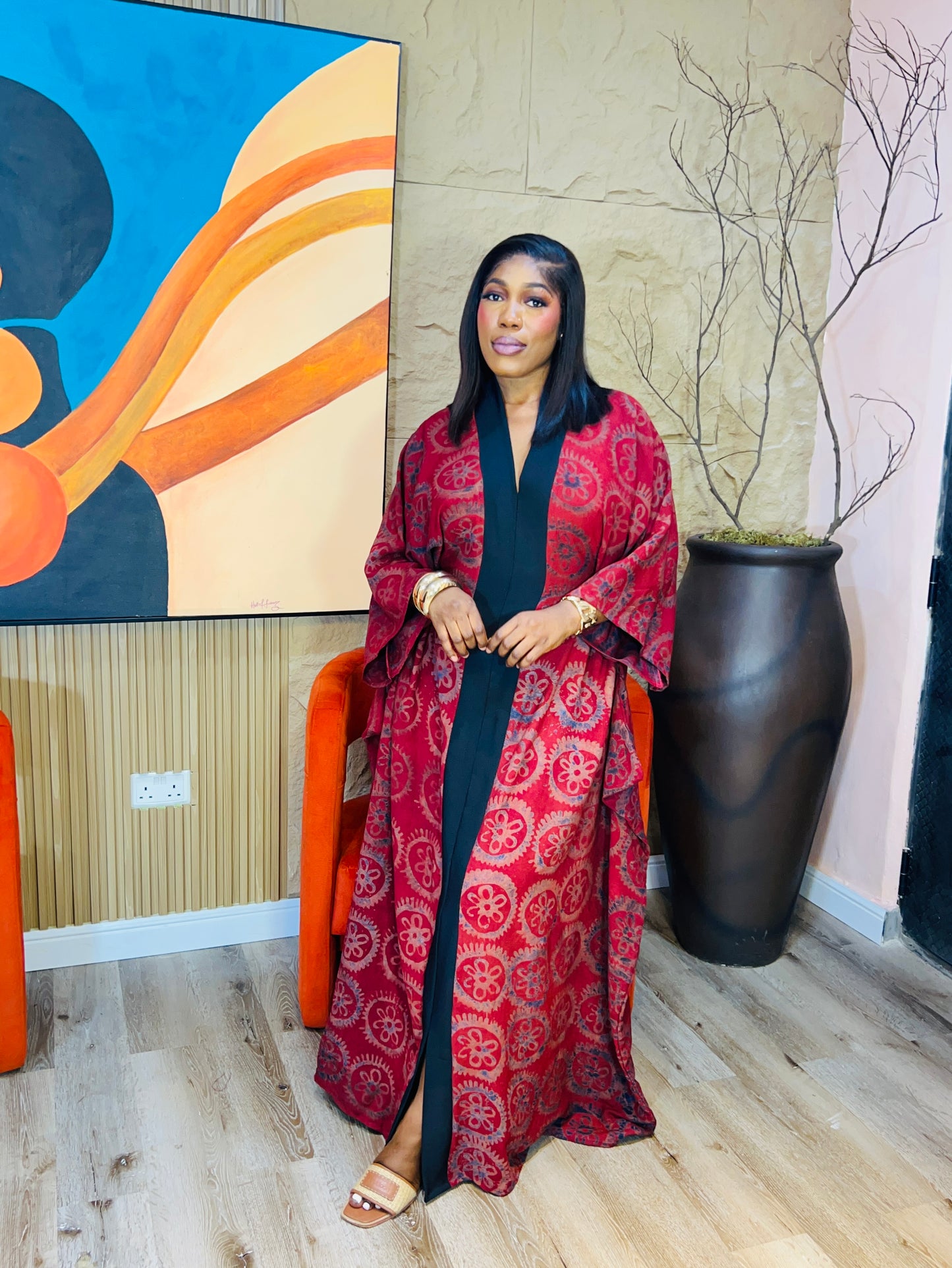 Woman wearing green Adire Crepe boubou with belt.