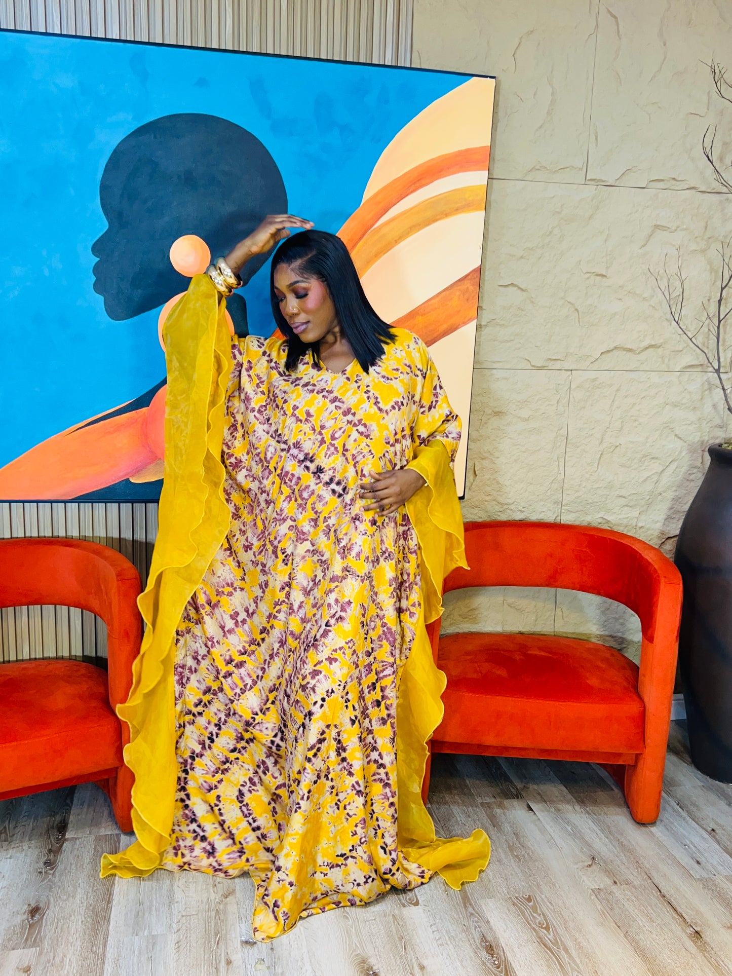 Elegant African woman in silk Adire boubou dress styled for a cultural event or casual day out