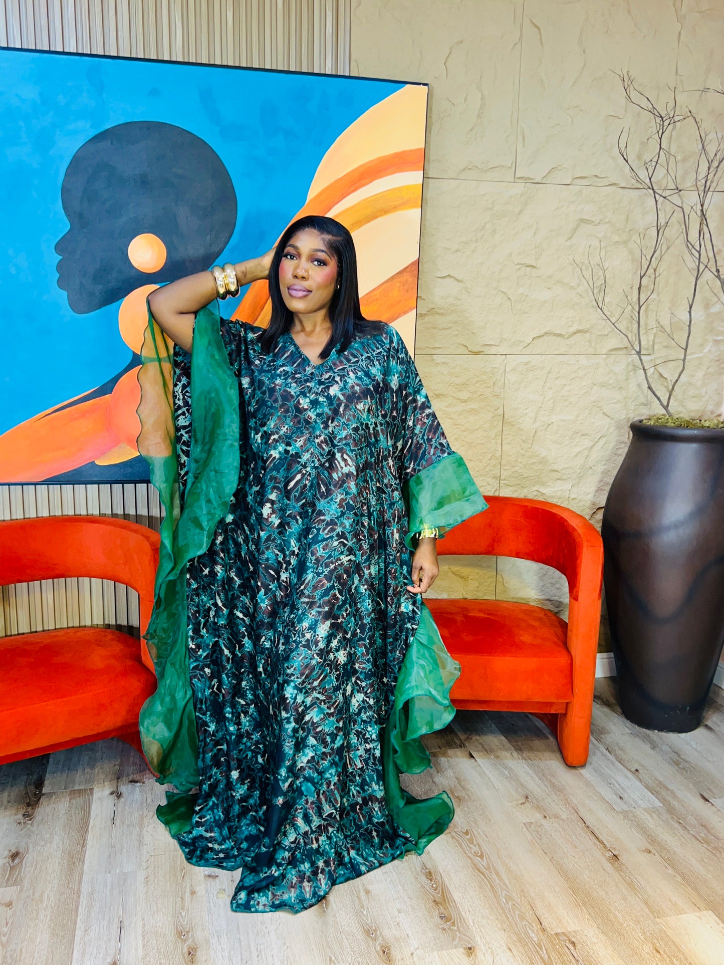 Elegant African woman in silk Adire boubou dress styled for a cultural event or casual day out