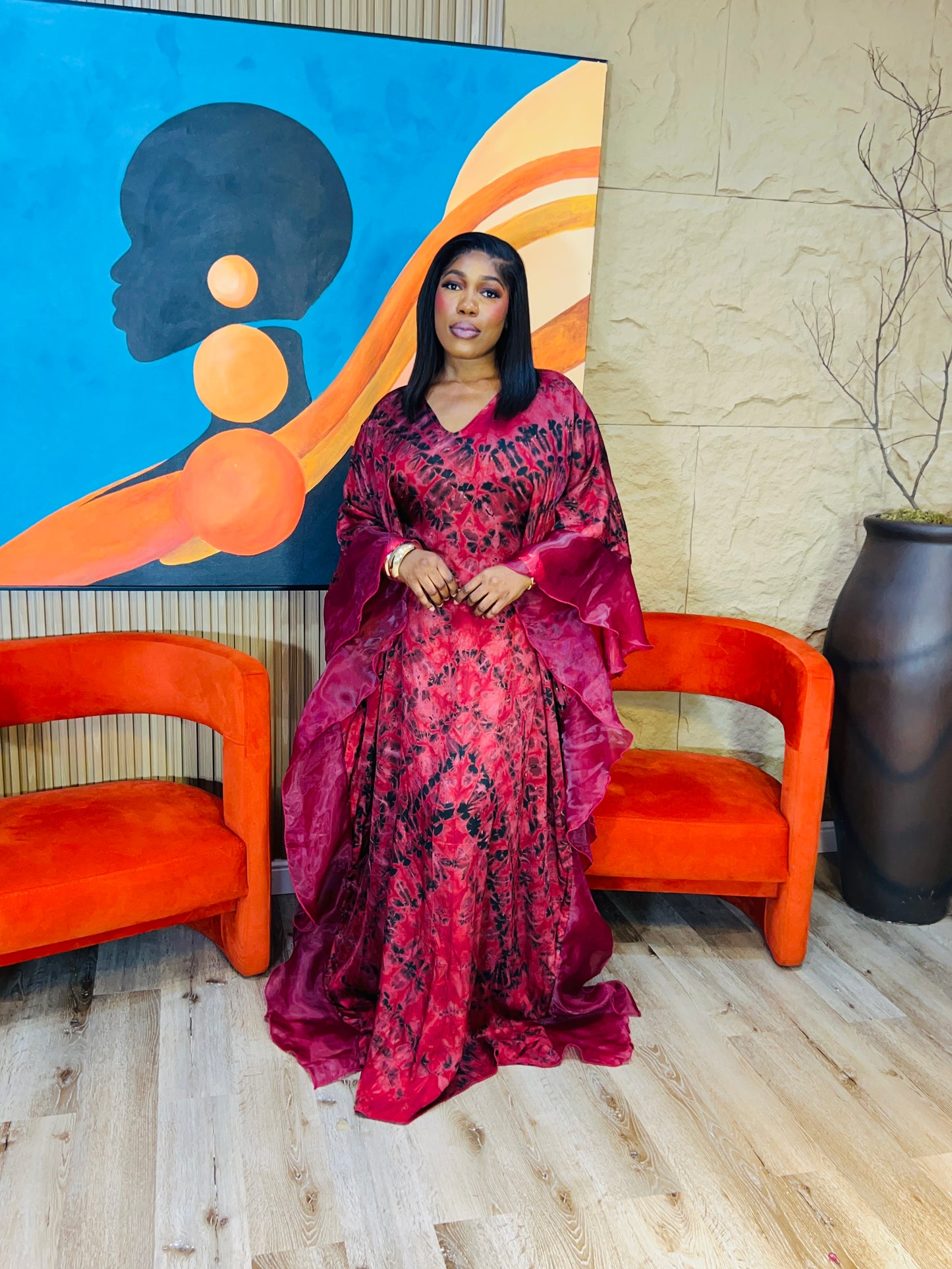 Elegant African woman in silk Adire boubou dress styled for a cultural event or casual day out