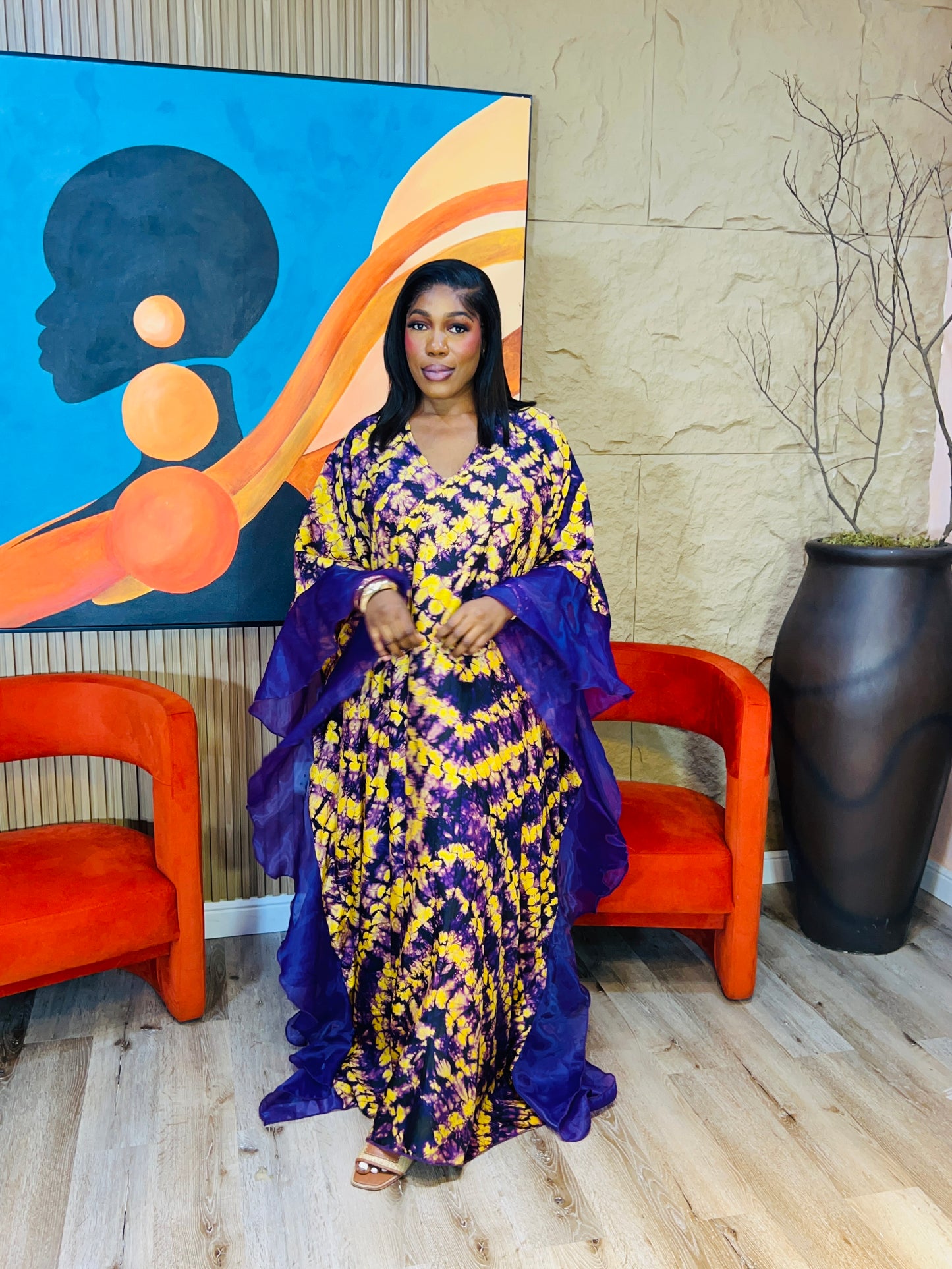 Elegant African woman in silk Adire boubou dress styled for a cultural event or casual day out