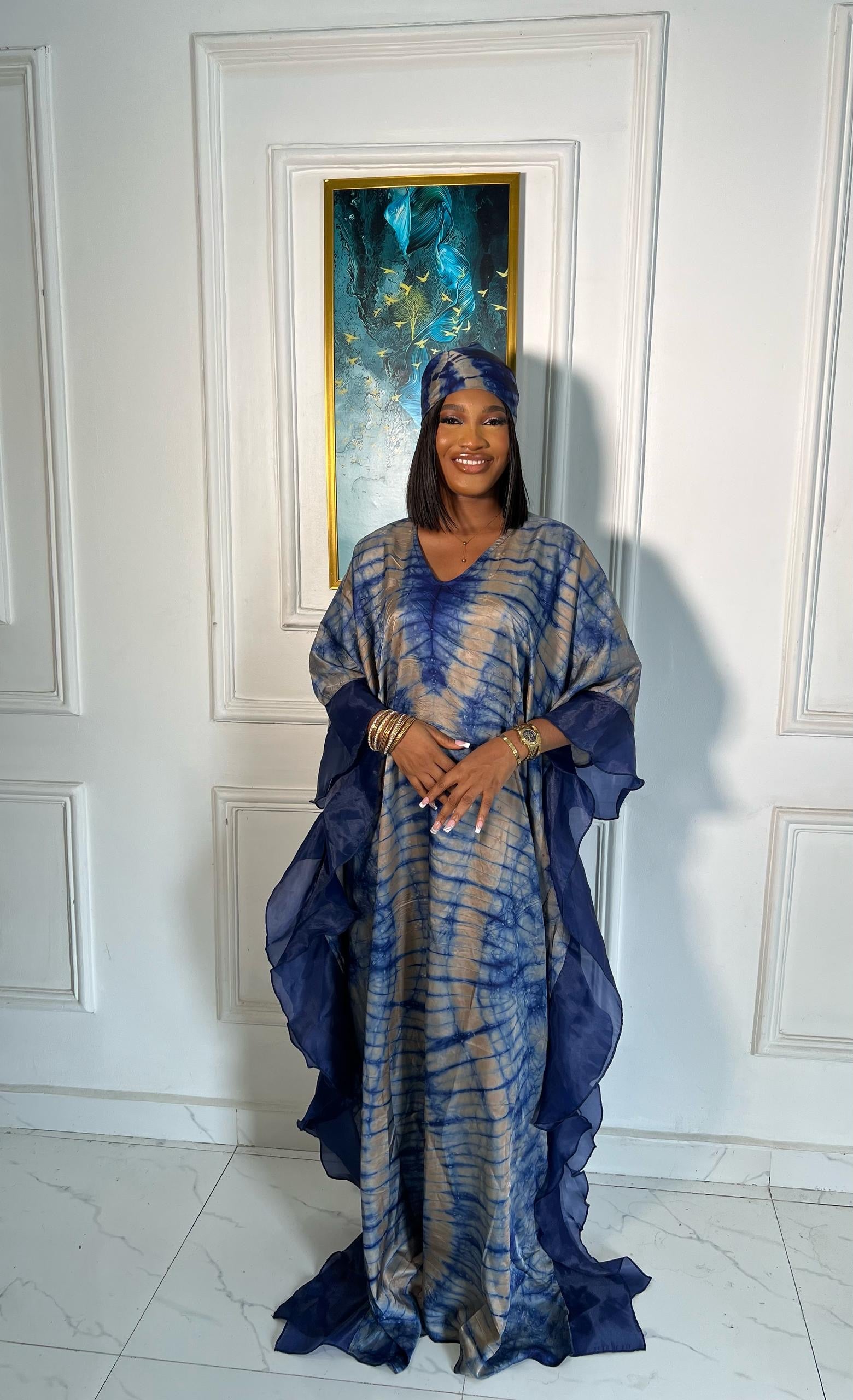 Elegant African woman in silk Adire boubou dress styled for a cultural event or casual day out