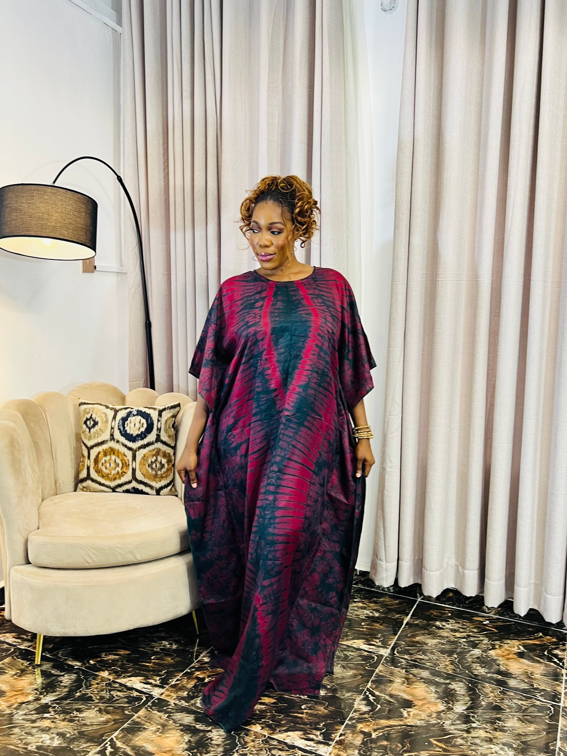 African woman wearing a handmade silk adire boubou dress – full-length traditional kaftan for women