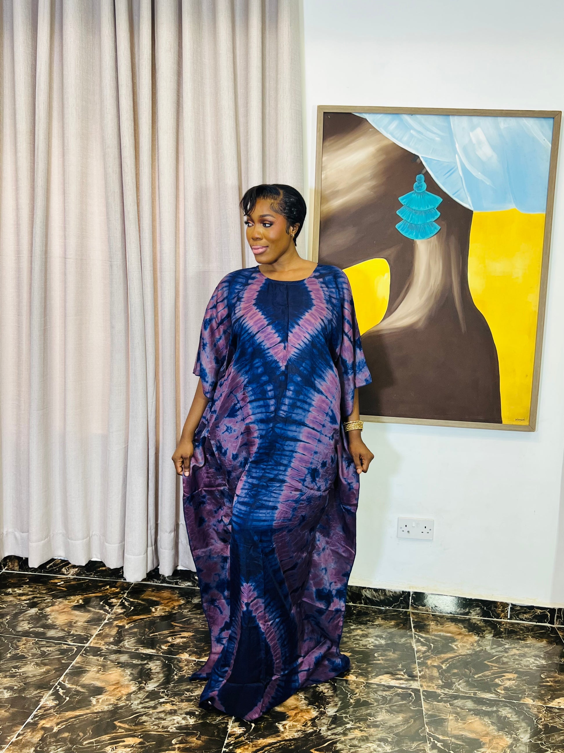 African woman wearing a handmade silk adire boubou dress – full-length traditional kaftan for women