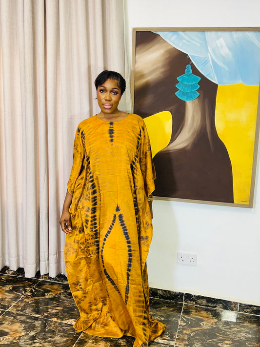 African woman wearing a handmade silk adire boubou dress – full-length traditional kaftan for women