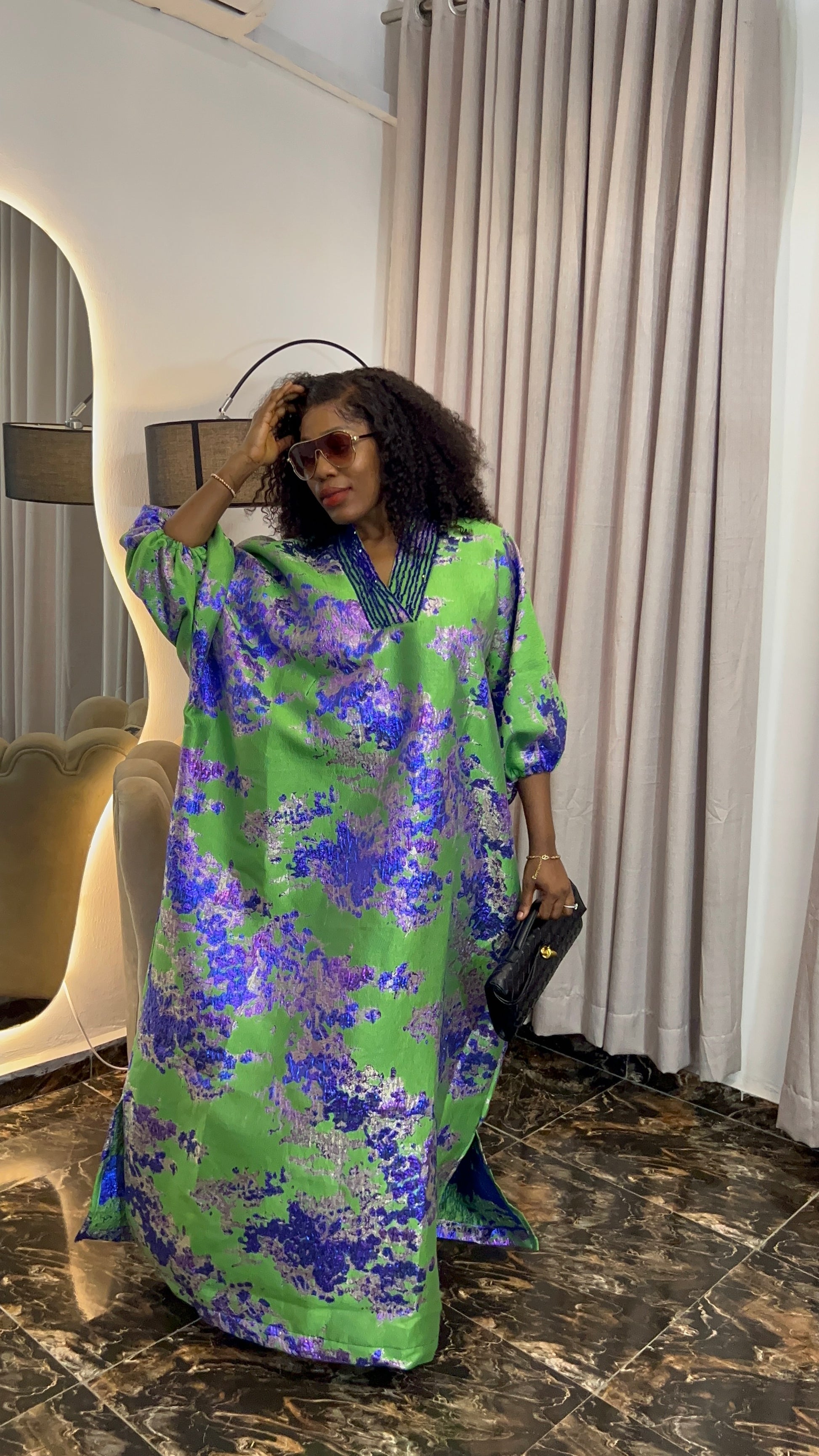 African woman in brocade boubou dress with crystal bead detail