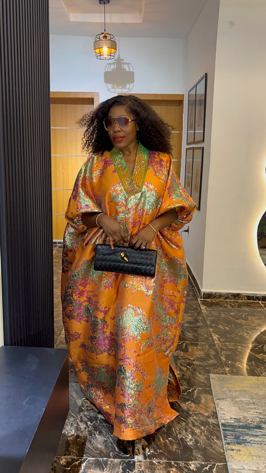 African woman in brocade boubou dress with crystal bead detail