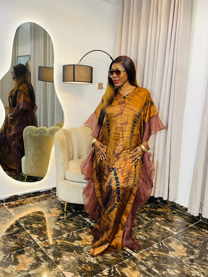 Elegant African woman in silk Adire boubou dress styled for a cultural event or casual day out