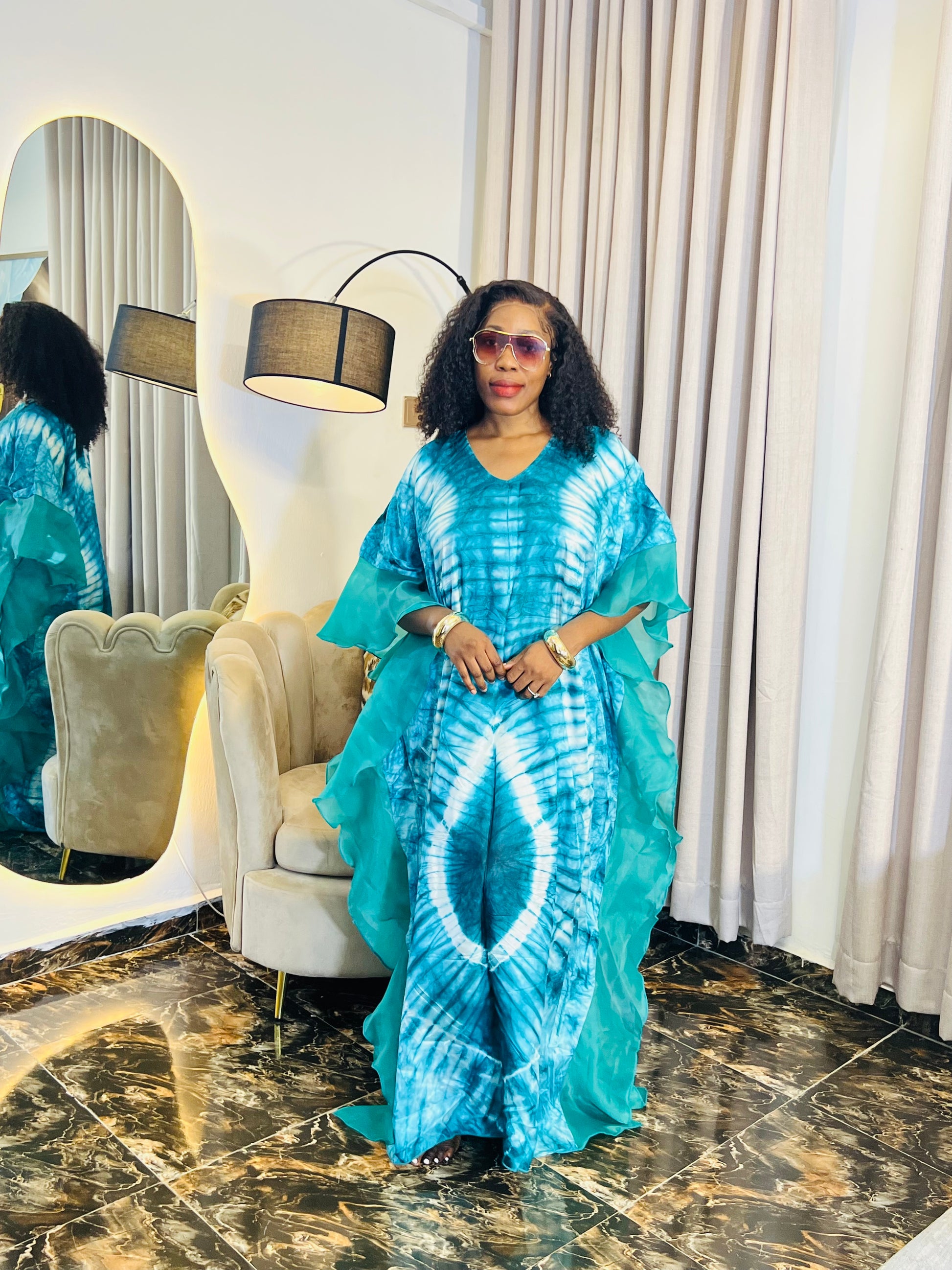 Elegant African woman in silk Adire boubou dress styled for a cultural event or casual day out