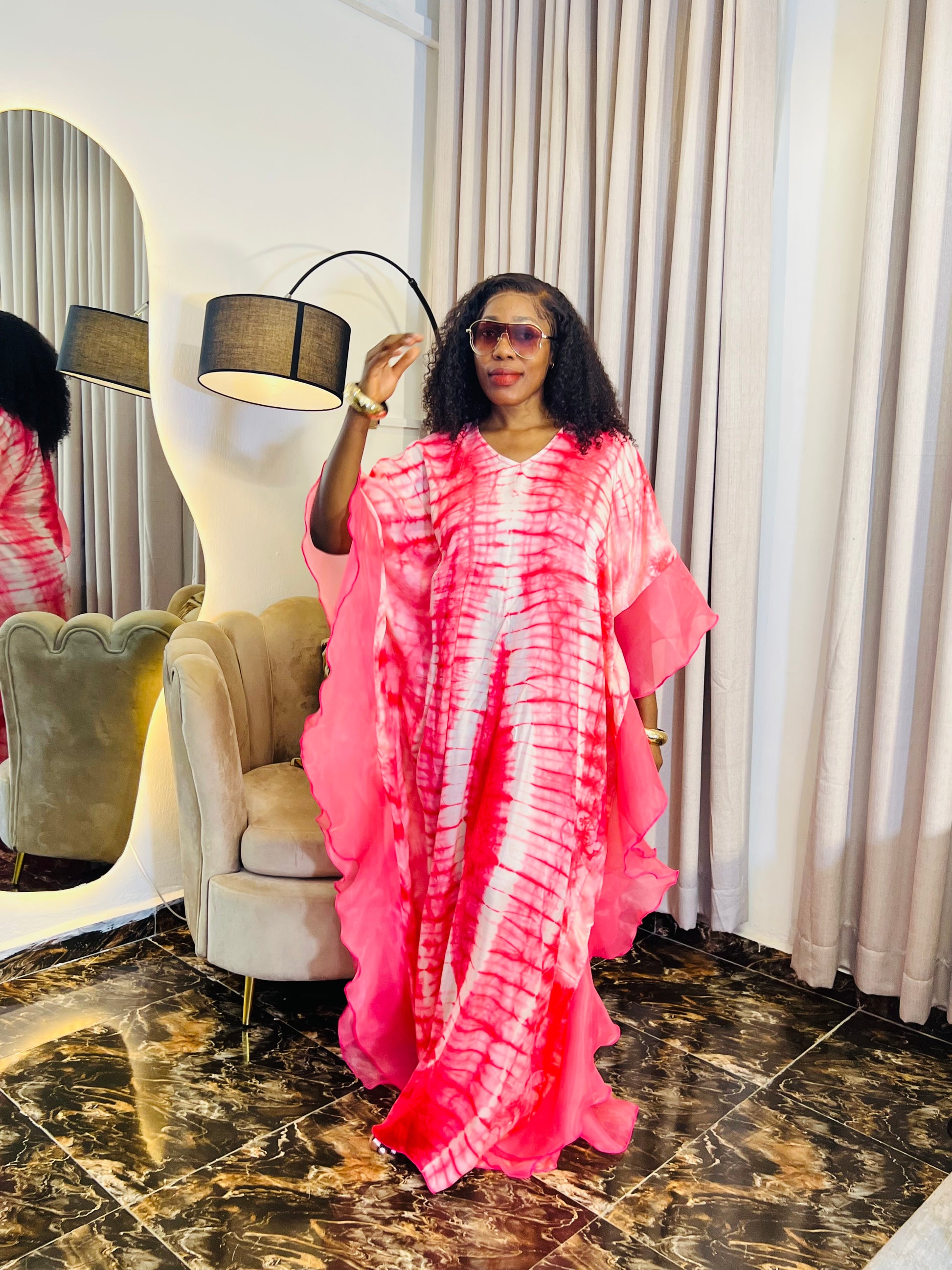 Elegant African woman in silk Adire boubou dress styled for a cultural event or casual day out