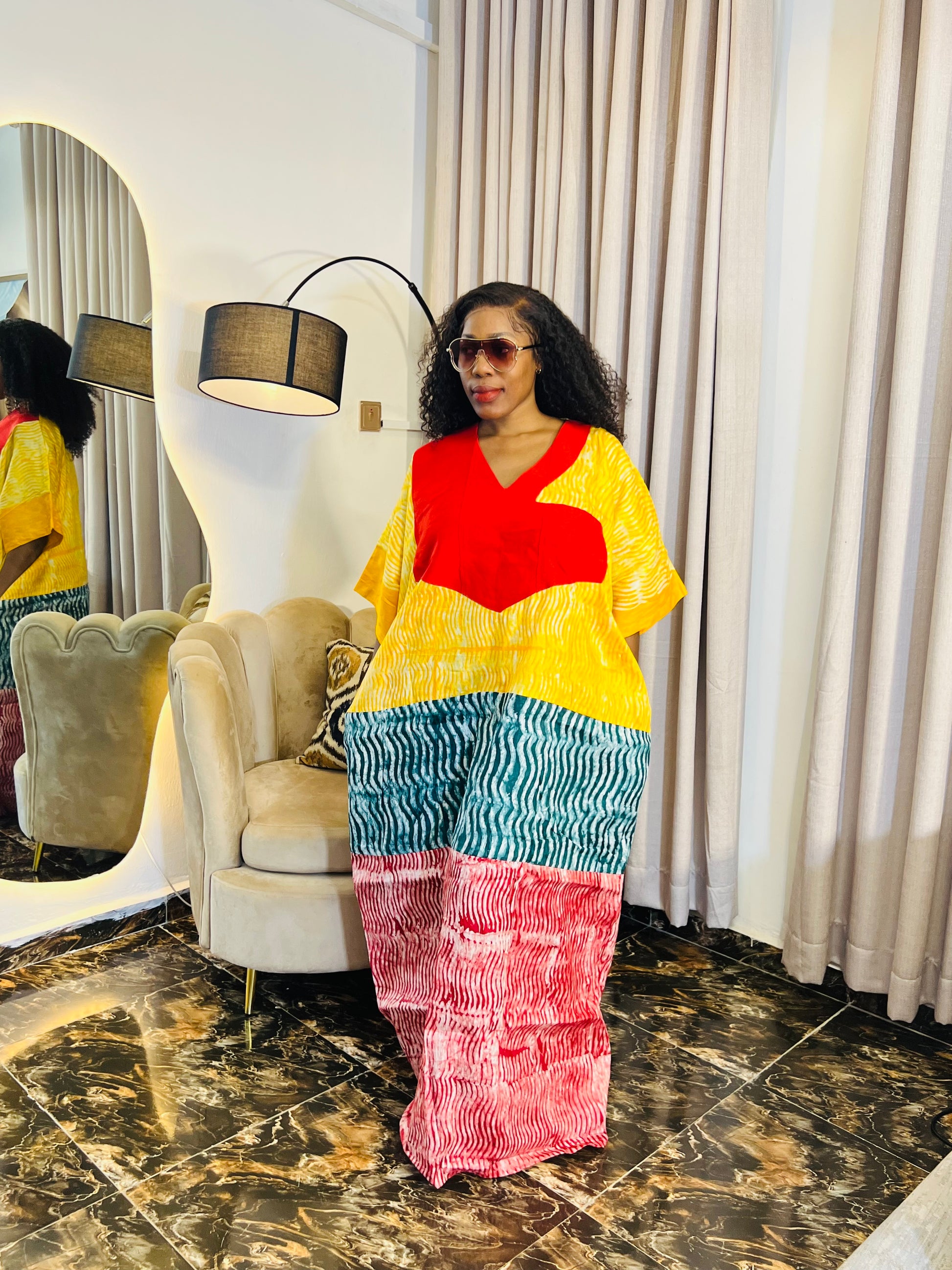 African woman wearing tie-dye bubu dress with Aso-Oke detail