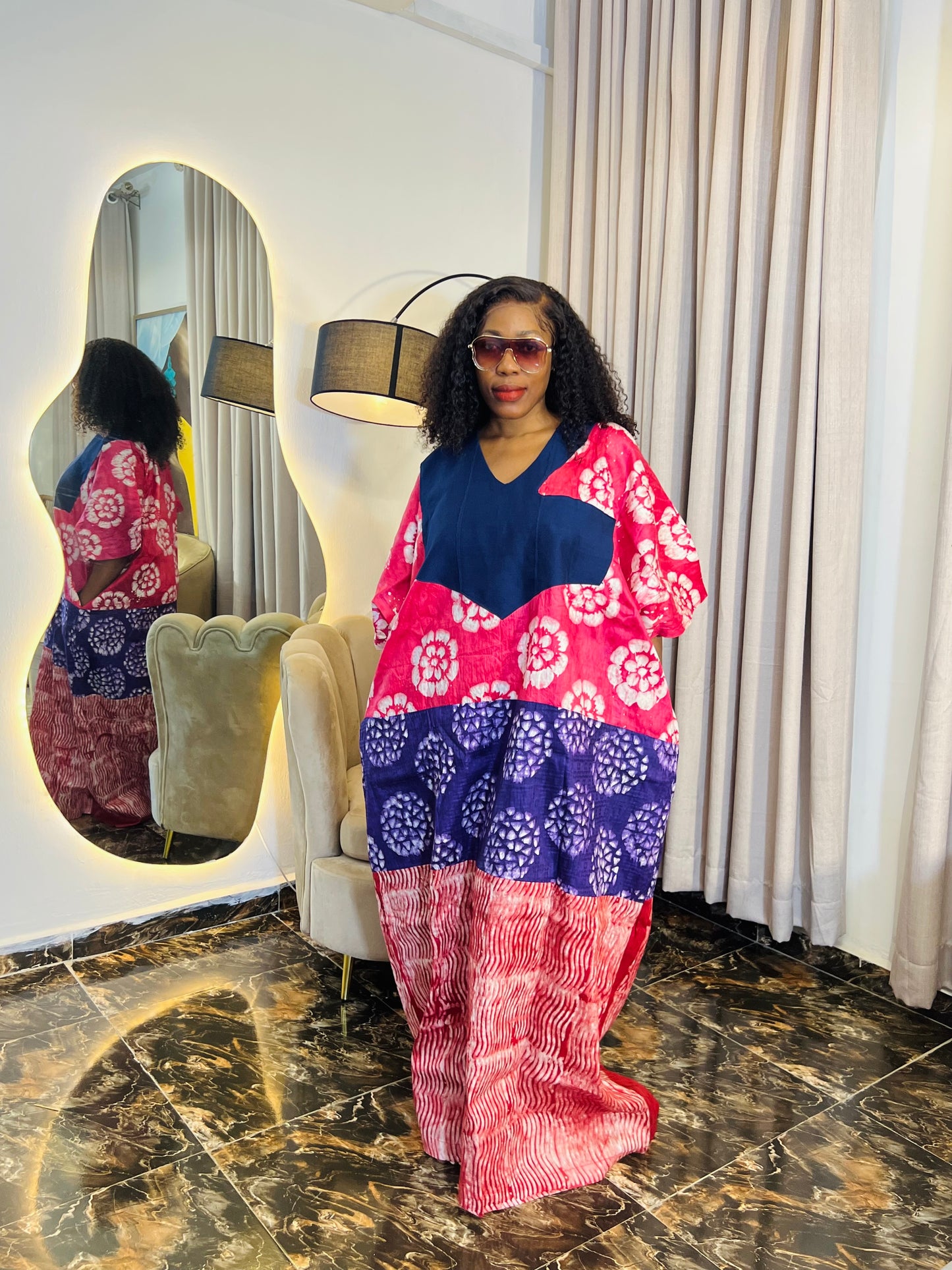 African woman wearing tie-dye bubu dress with Aso-Oke detail