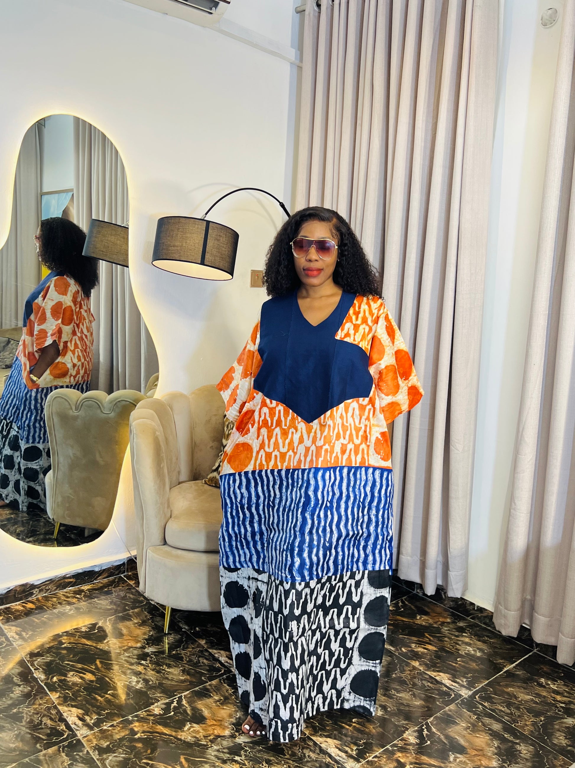 African woman wearing tie-dye bubu dress with Aso-Oke detail