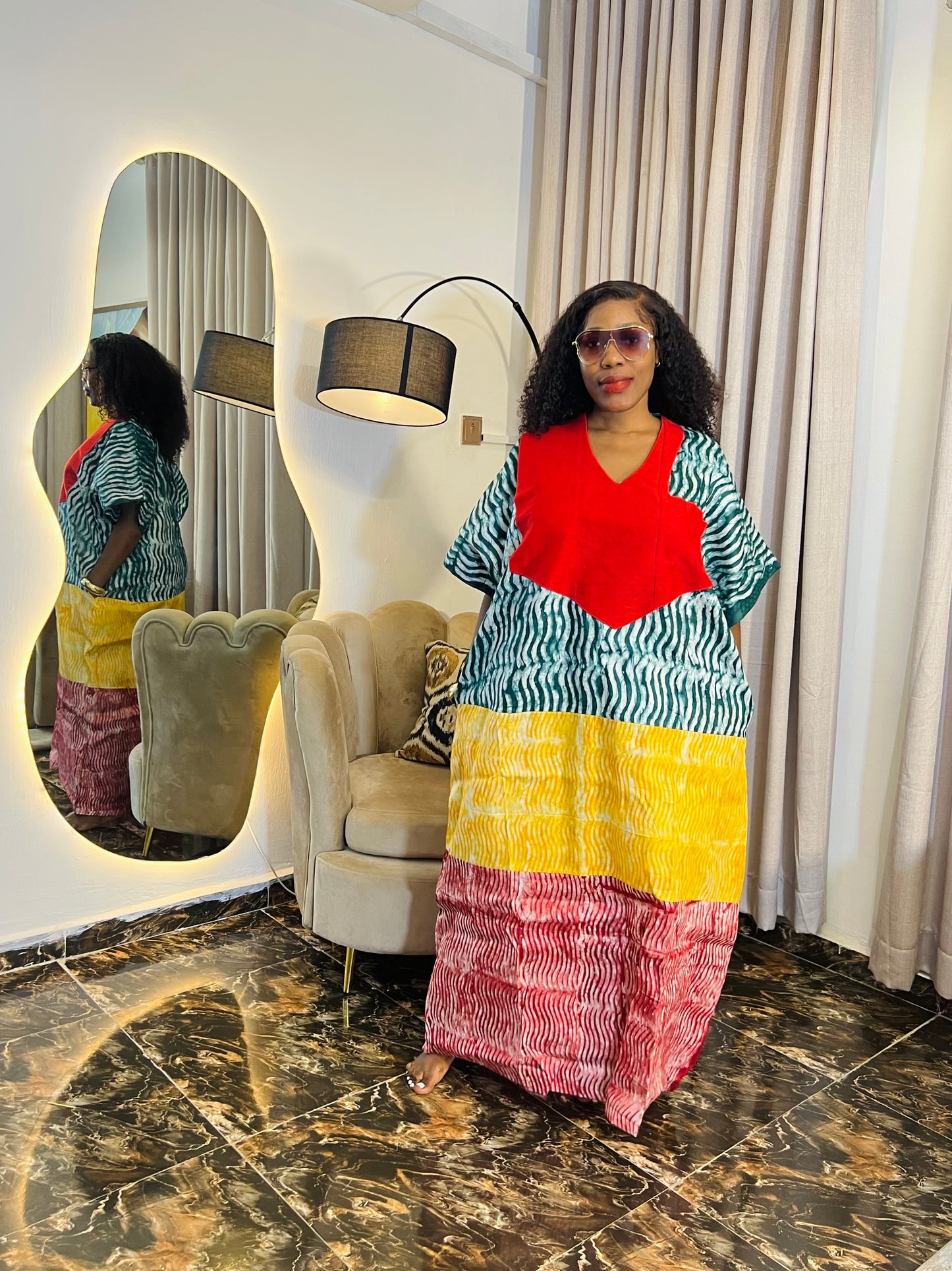African woman wearing tie-dye bubu dress with Aso-Oke detail