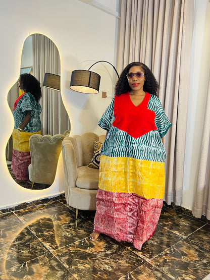 African woman wearing tie-dye bubu dress with Aso-Oke detail