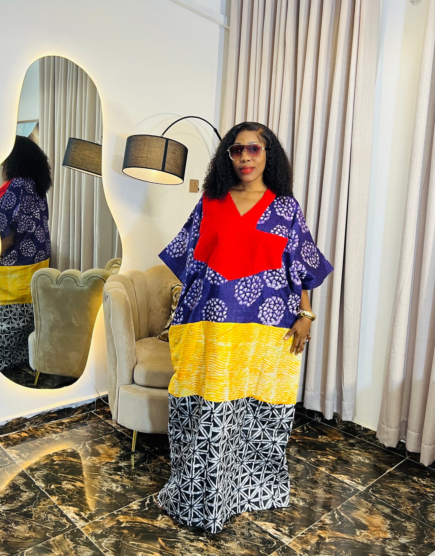 African woman wearing tie-dye bubu dress with Aso-Oke detail
