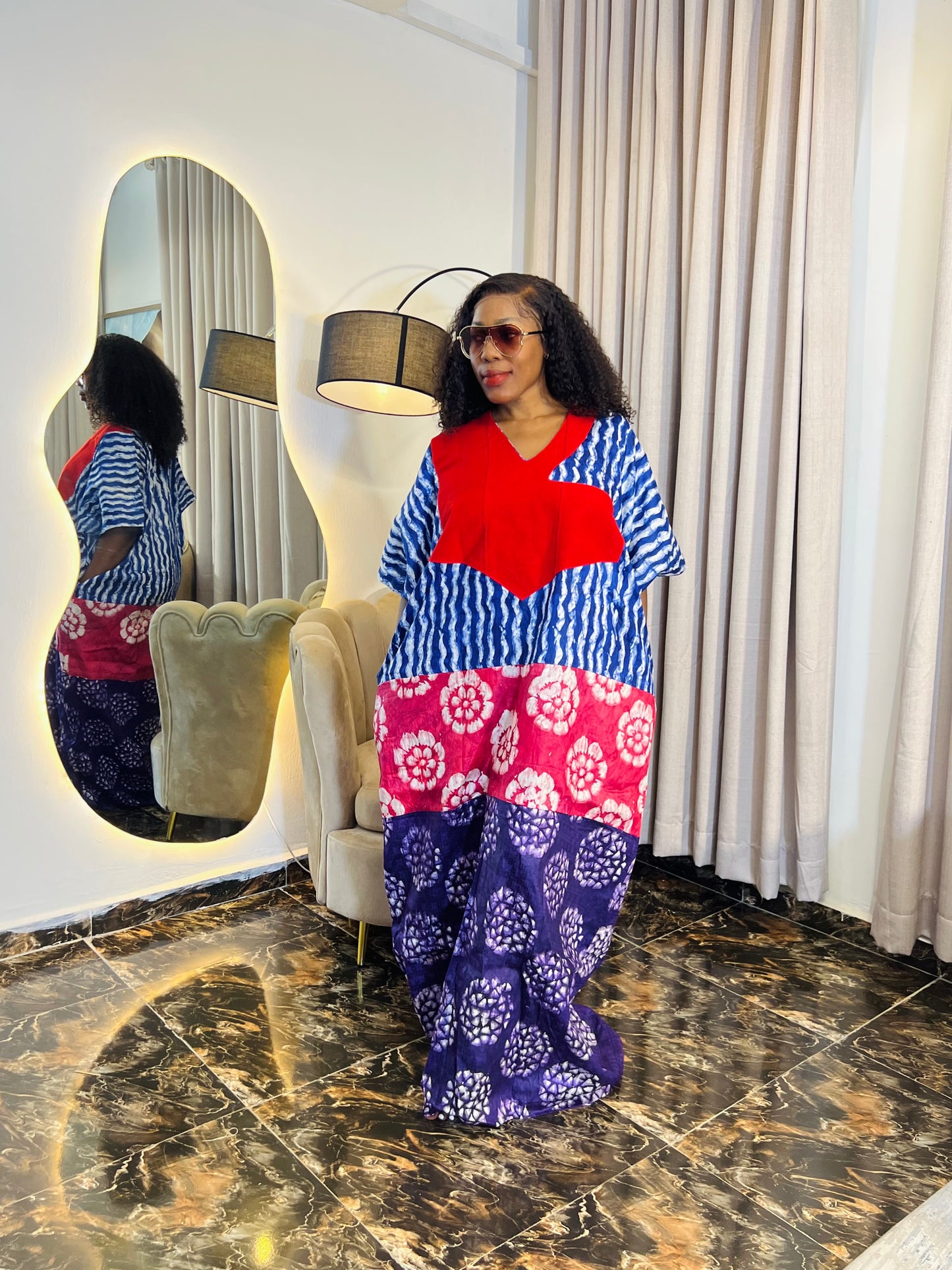 African woman wearing tie-dye bubu dress with Aso-Oke detail