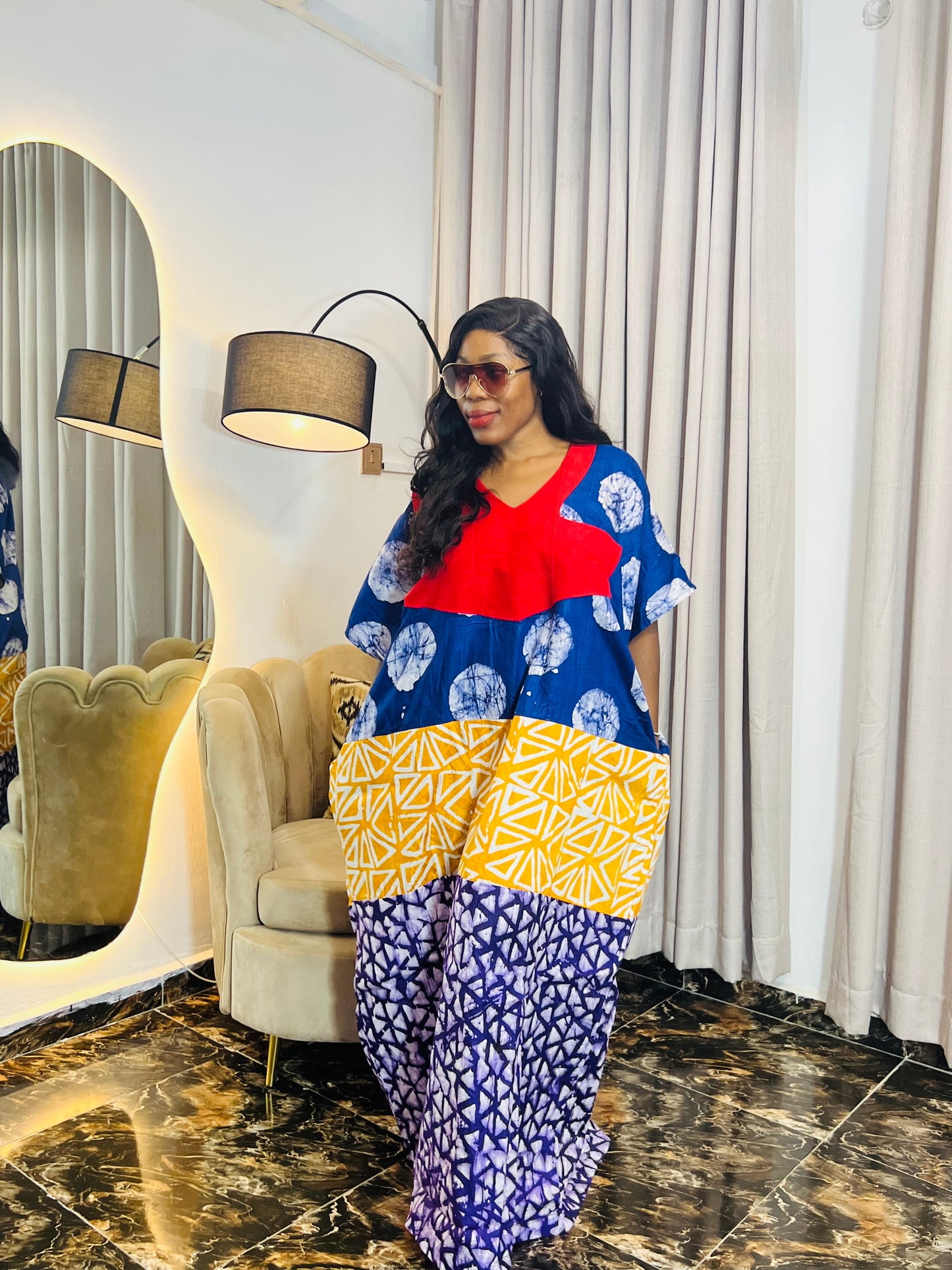 African woman wearing tie-dye bubu dress with Aso-Oke detail