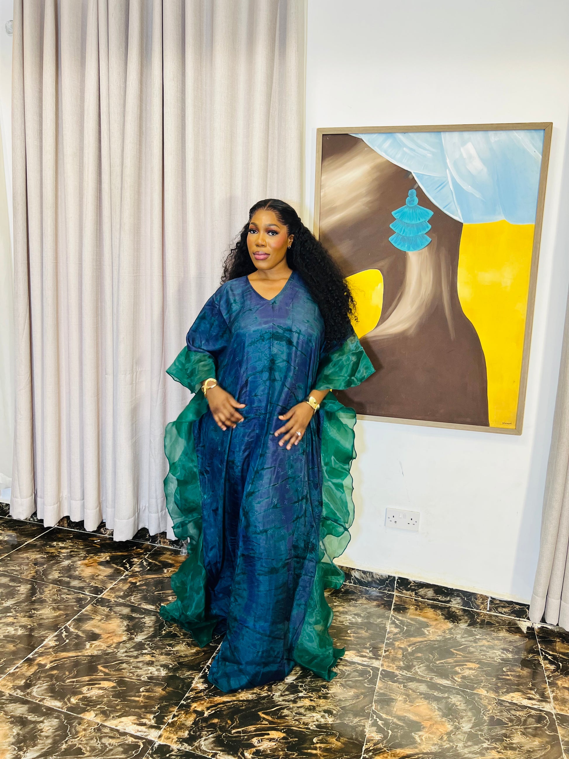 Elegant African woman in silk Adire boubou dress styled for a cultural event or casual day out
