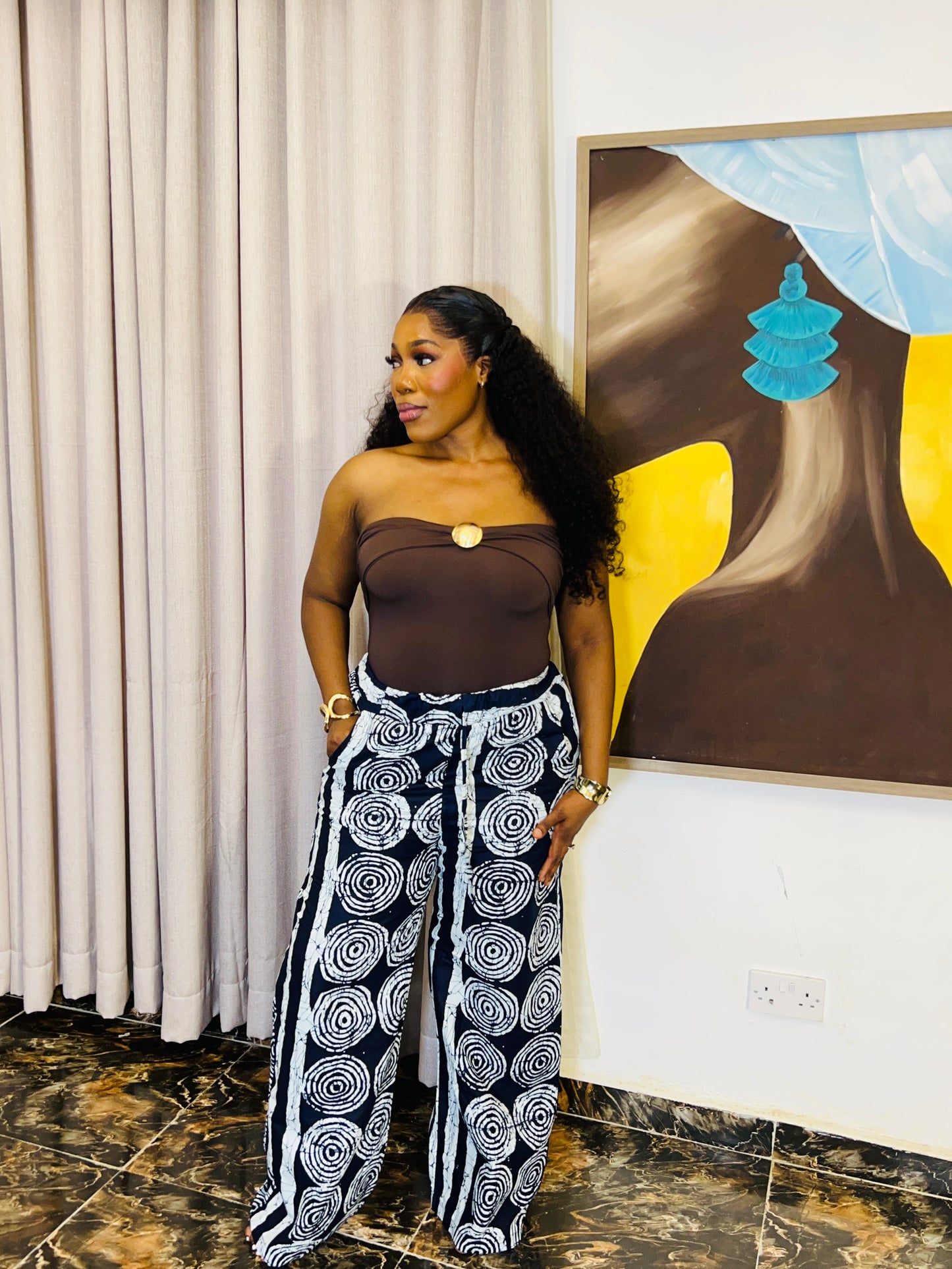 Wide-leg Ankara pants in bold spiral print, styled for soft life days.
