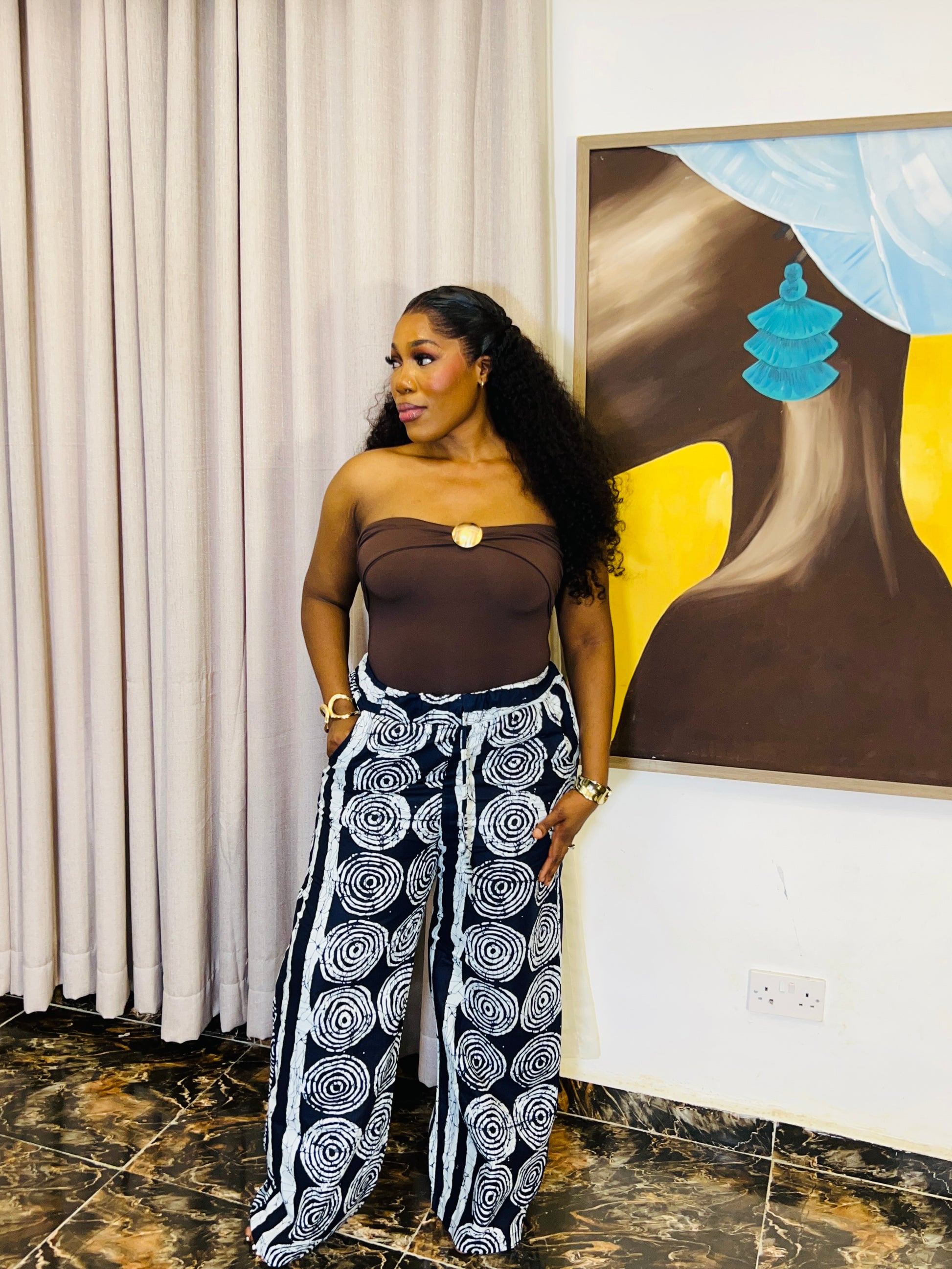 Wide-leg Ankara pants in bold spiral print, styled for soft life days.
