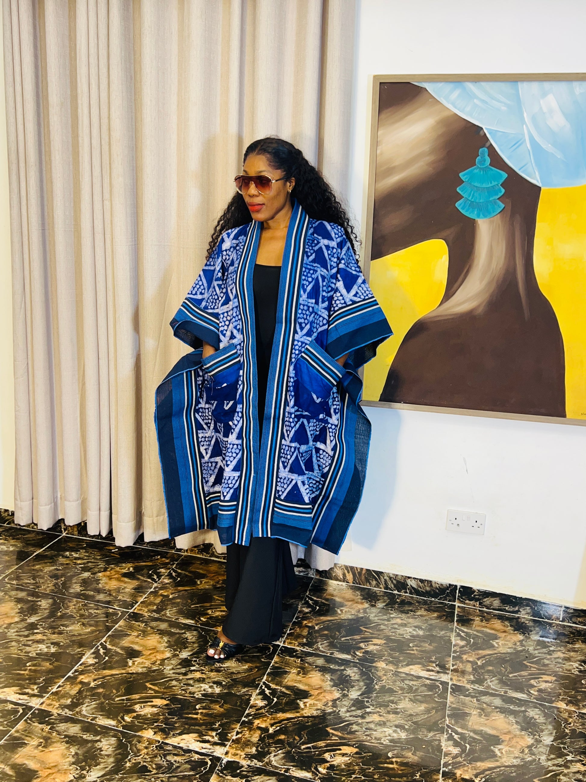 African woman wearing handmade Adire kimono jacket with Aso-Oke trim – one size fits most