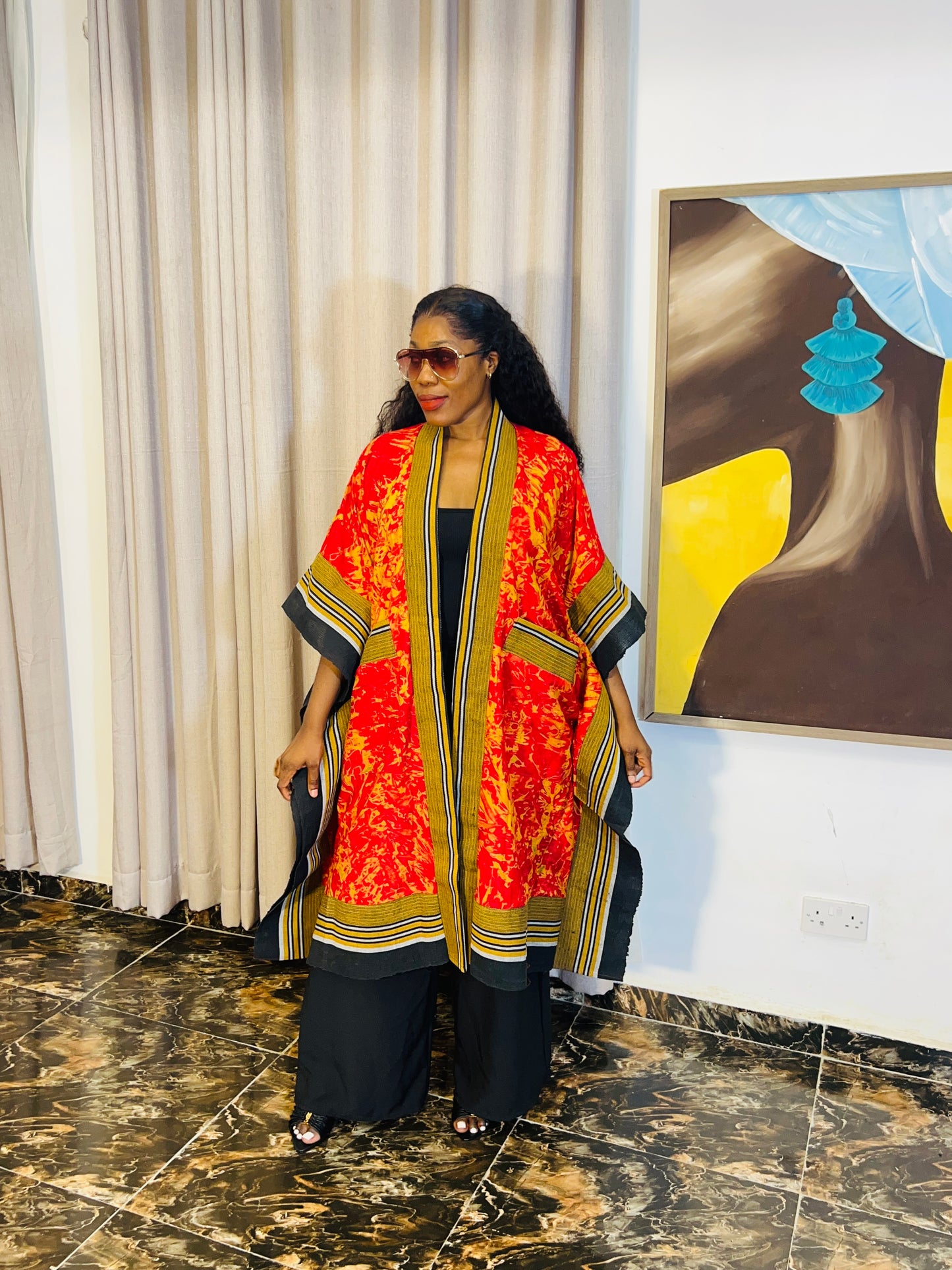 African woman wearing handmade Adire kimono jacket with Aso-Oke trim – one size fits most