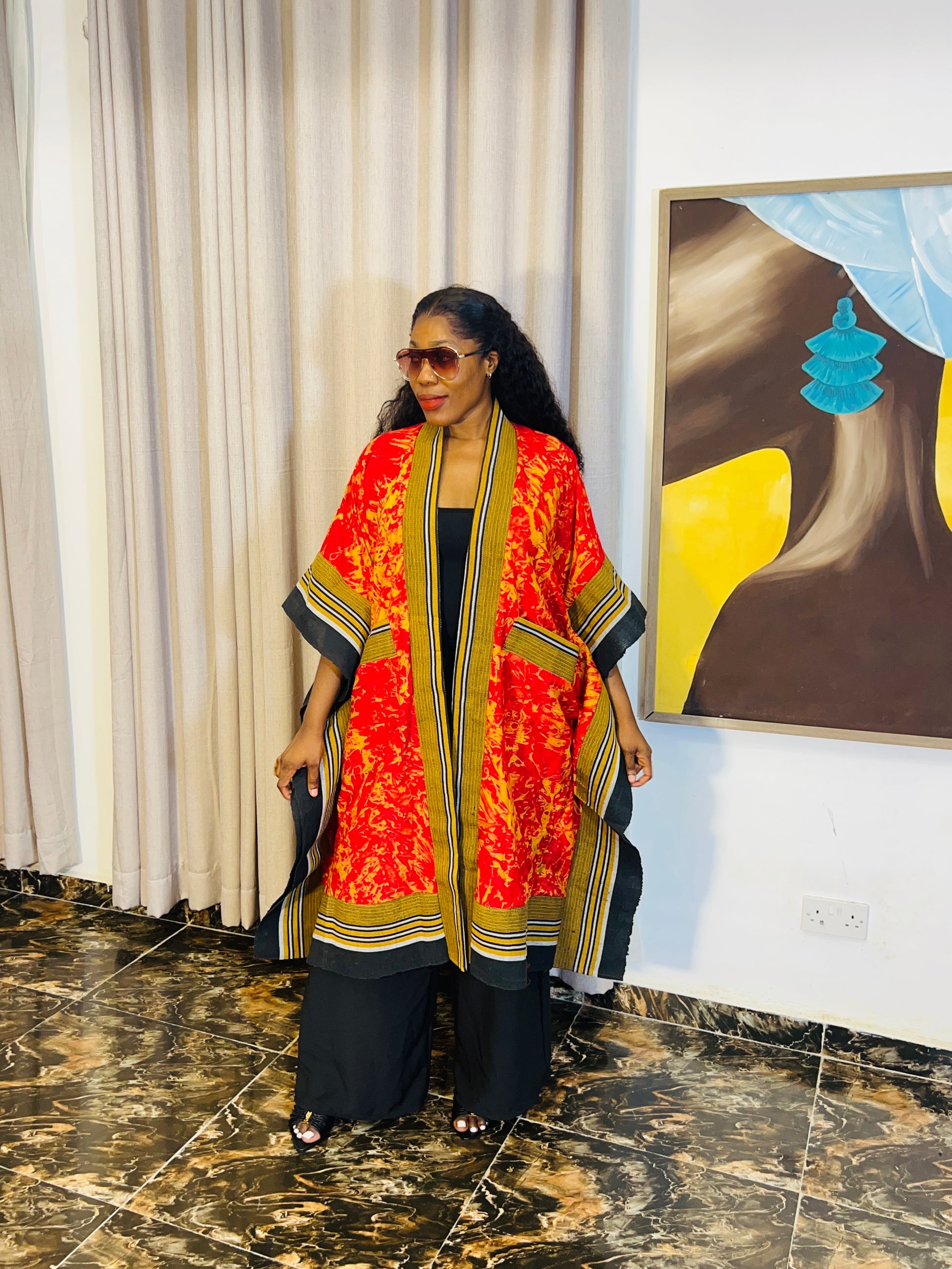African woman wearing handmade Adire kimono jacket with Aso-Oke trim – one size fits most