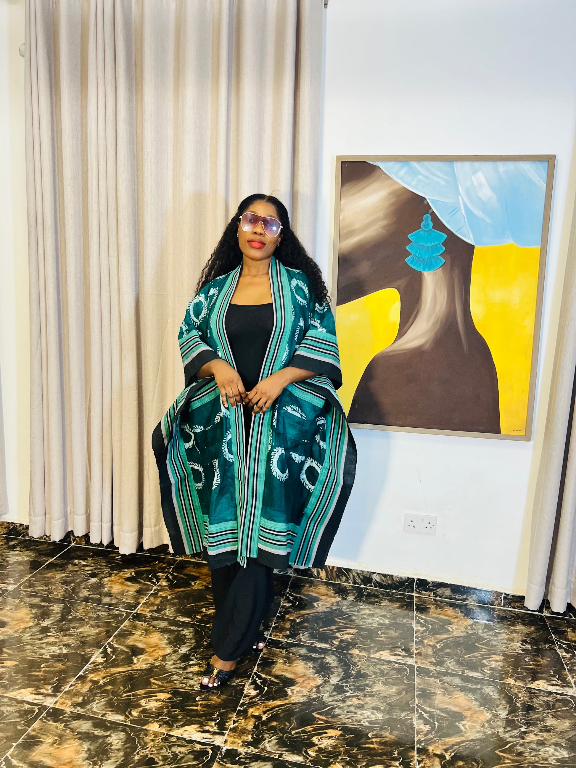 African woman wearing handmade Adire kimono jacket with Aso-Oke trim – one size fits most