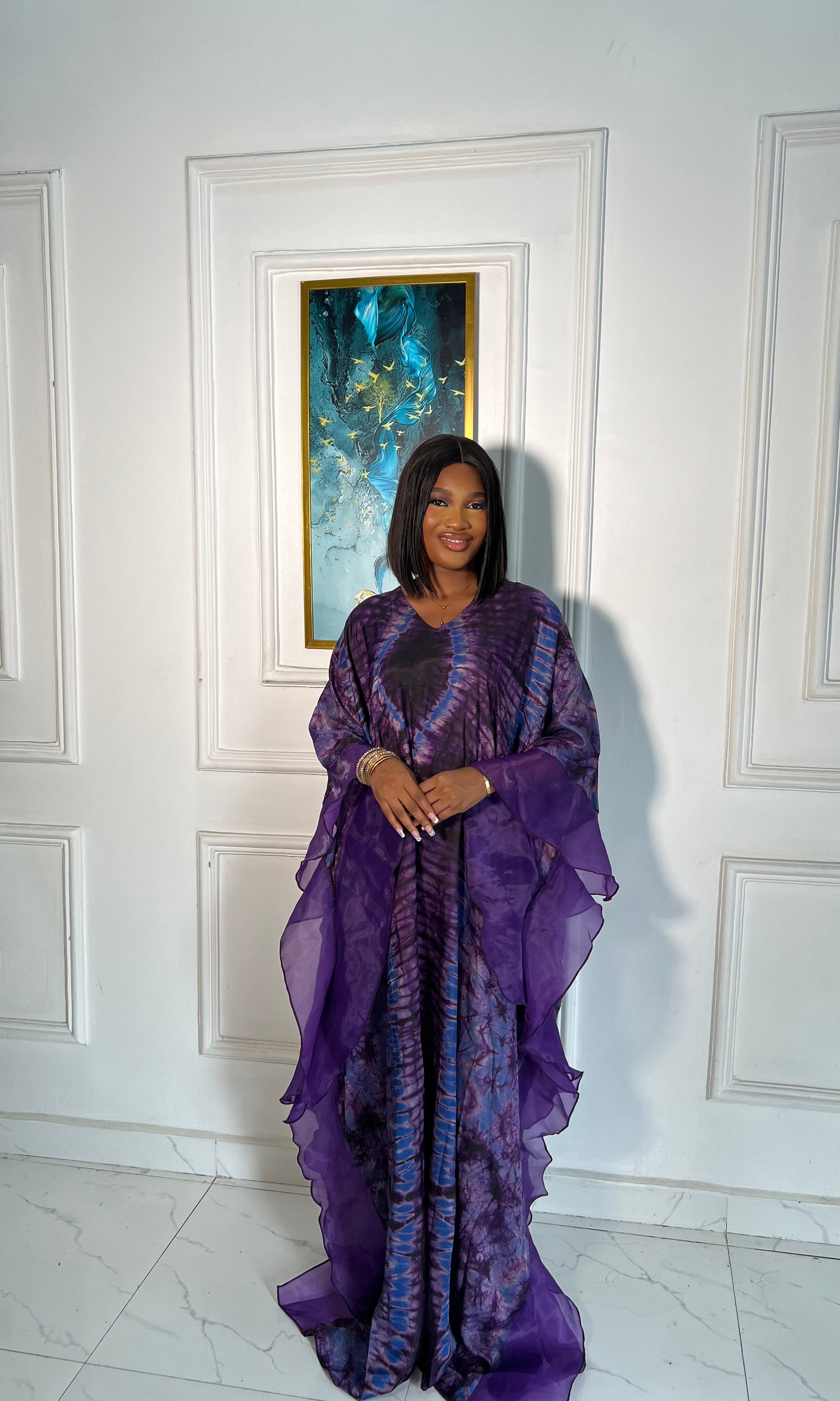 Elegant African woman in silk Adire boubou dress styled for a cultural event or casual day out