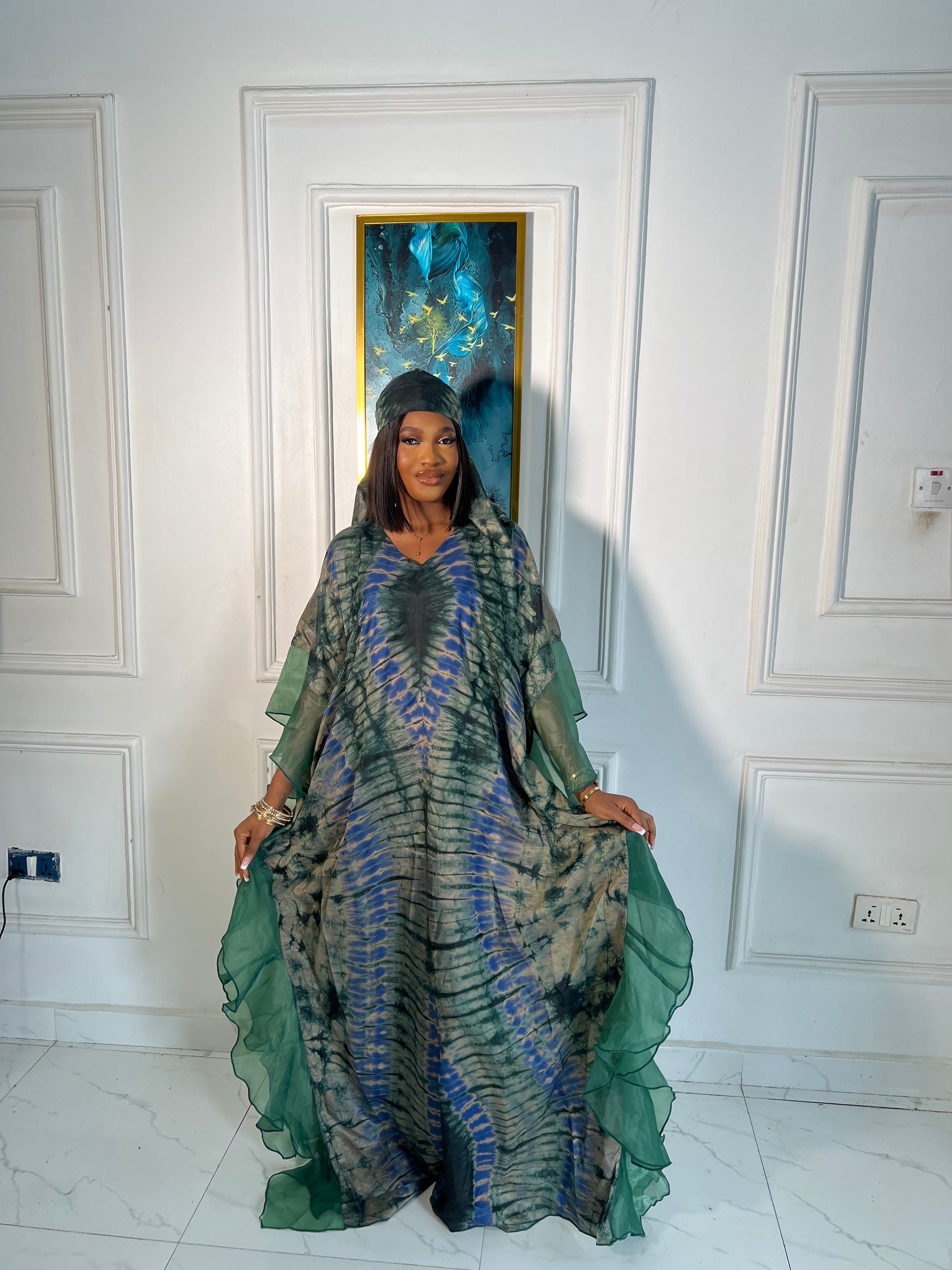 Elegant African woman in silk Adire boubou dress styled for a cultural event or casual day out