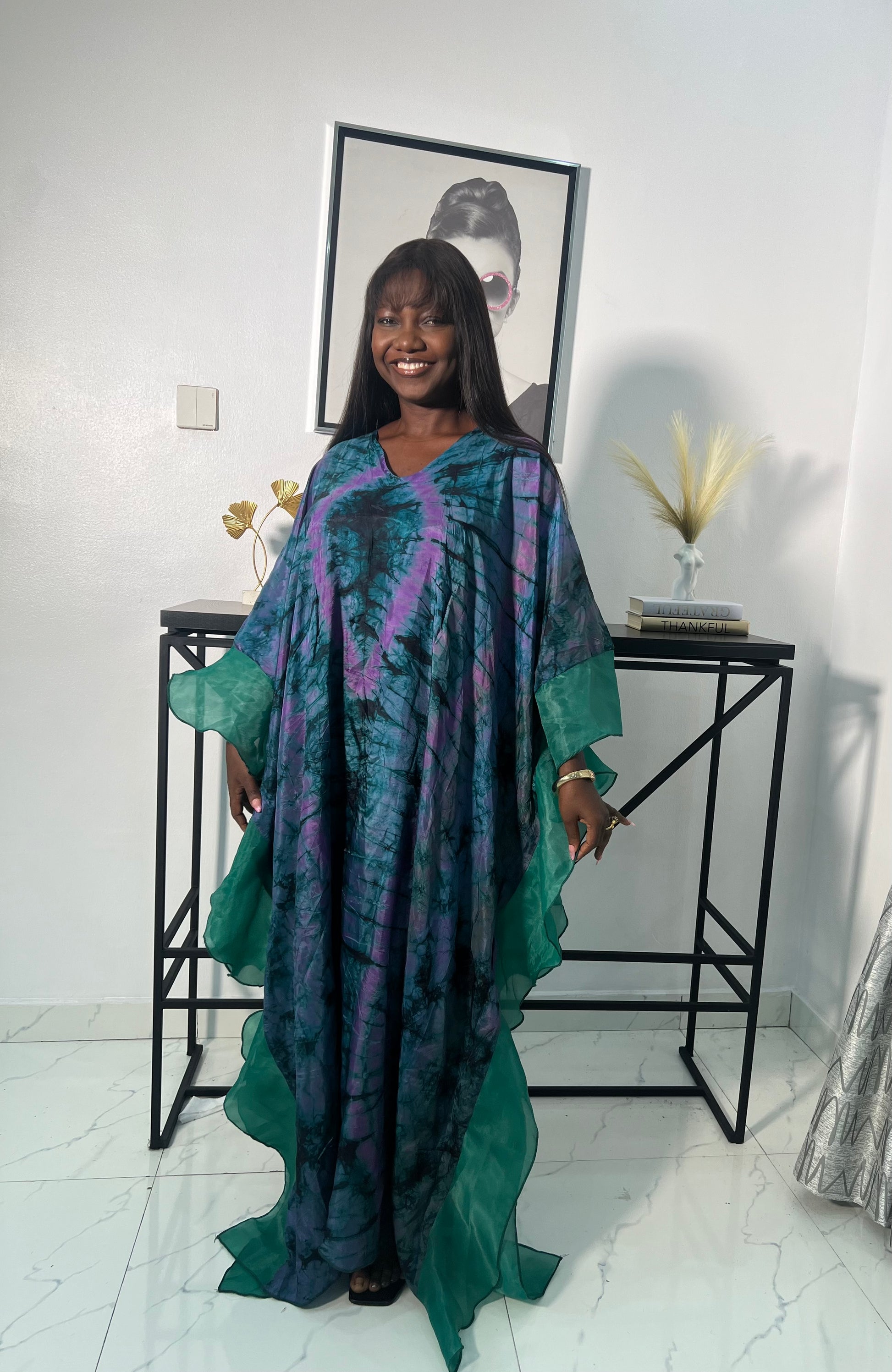 Elegant African woman in silk Adire boubou dress styled for a cultural event or casual day out