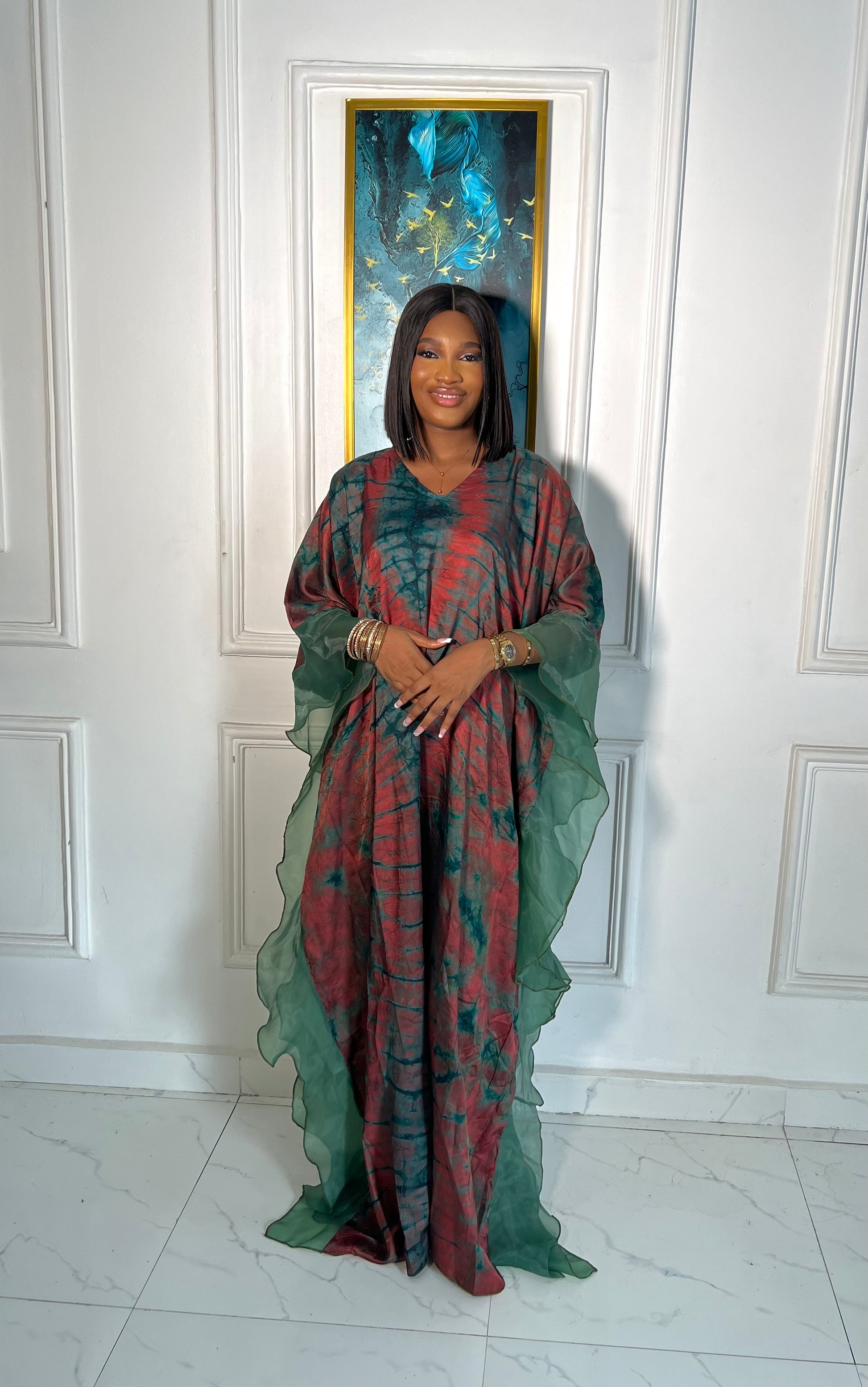 Elegant African woman in silk Adire boubou dress styled for a cultural event or casual day out