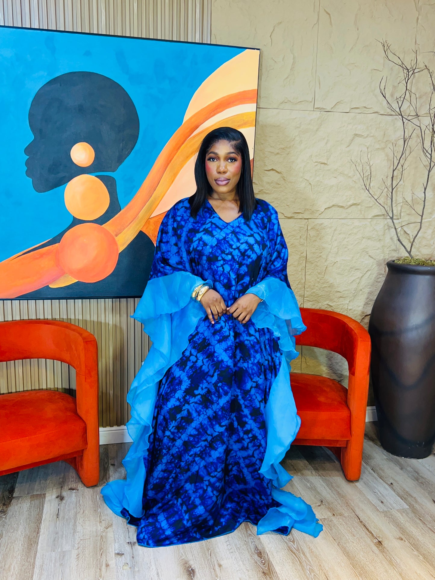Elegant African woman in silk Adire boubou dress styled for a cultural event or casual day out