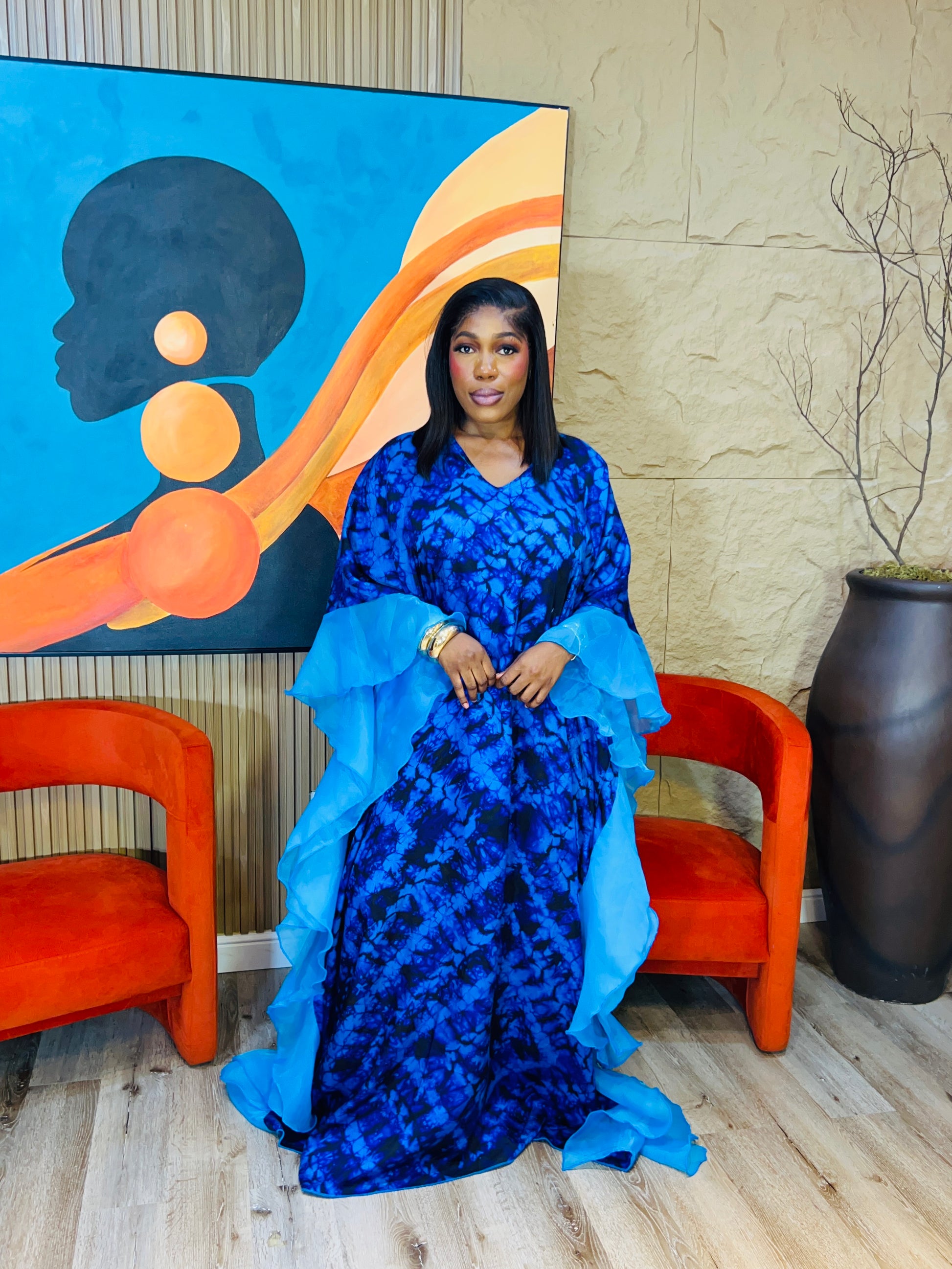 Elegant African woman in silk Adire boubou dress styled for a cultural event or casual day out