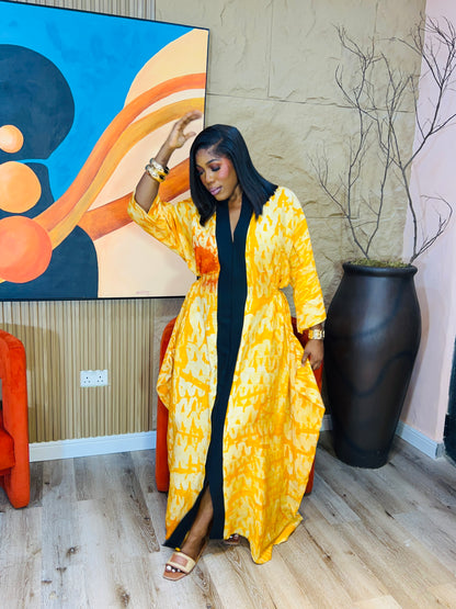 Woman wearing green Adire Crepe boubou with belt. 