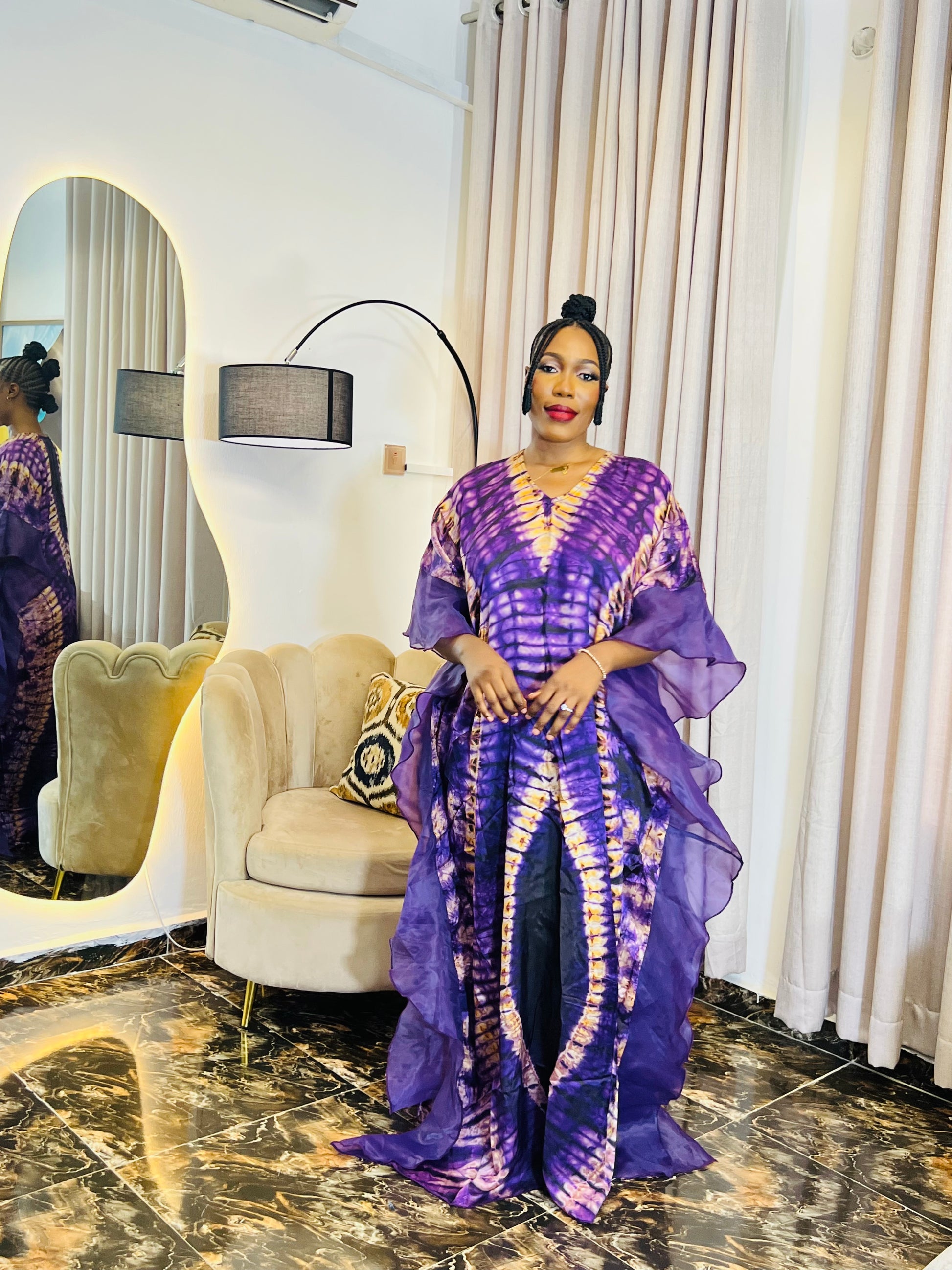 Elegant African woman in silk Adire boubou dress styled for a cultural event or casual day out