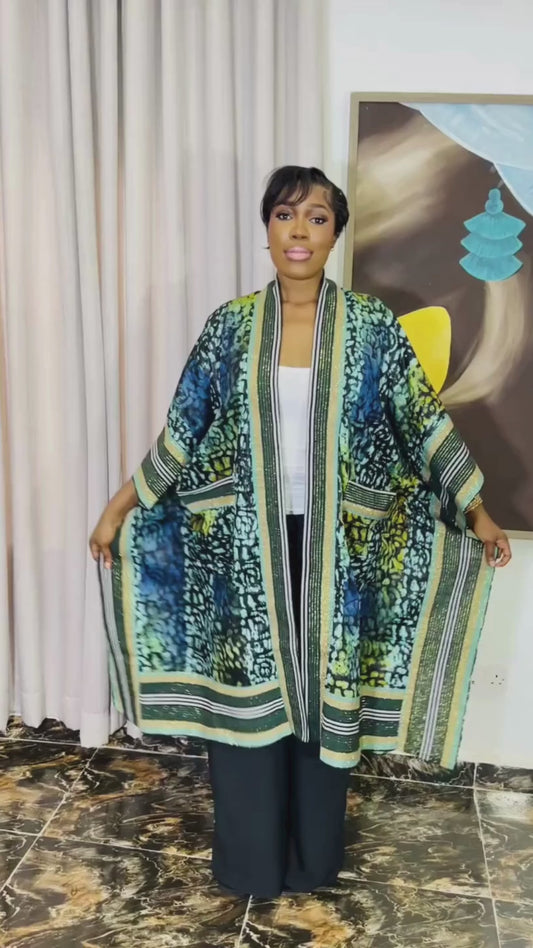 African woman wearing handmade Adire kimono jacket with Aso-Oke trim – one size fits most