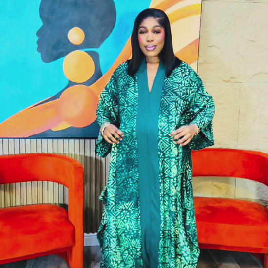 Woman wearing green Adire Crepe boubou with belt. 