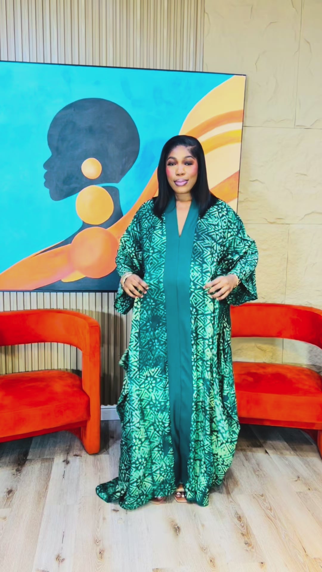 Woman wearing green Adire Crepe boubou with belt. 